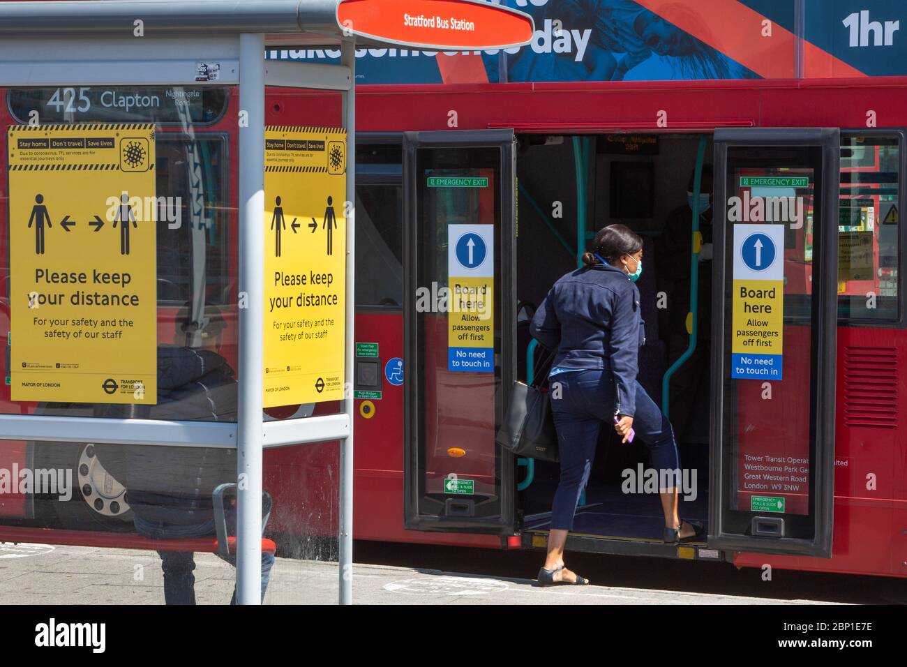 May 2020: Essential workers wait to board a double decker bus on public transport in London Stock Photo