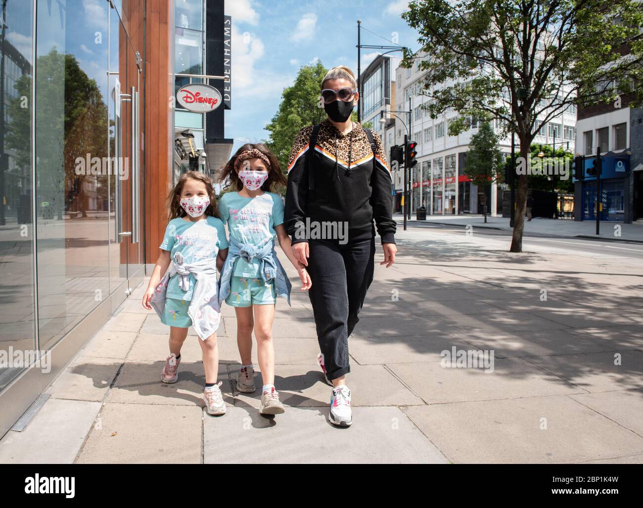 Two young girls playing in the street wearing face masks during the ...