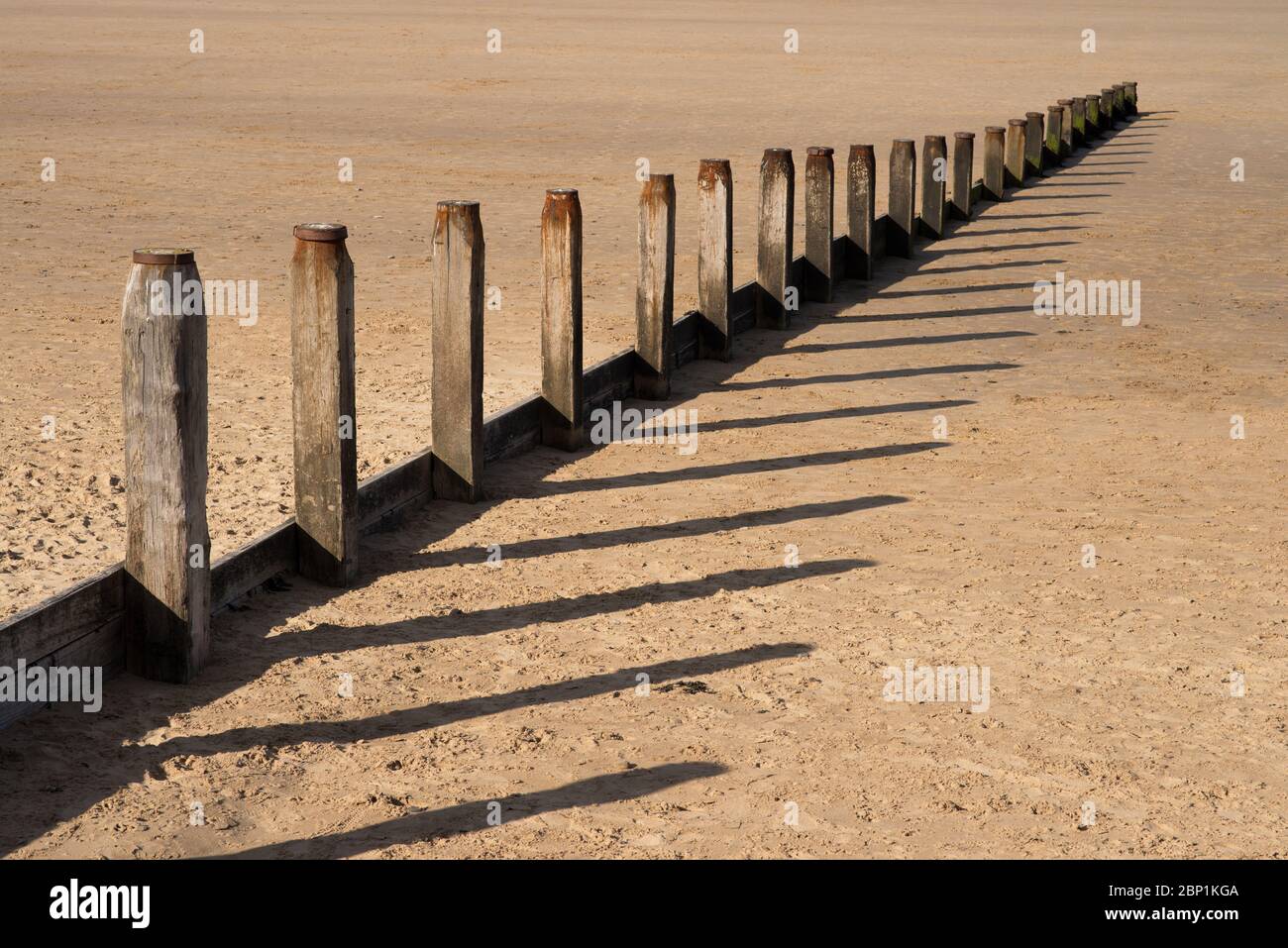 Groyne on a beach at low tide Stock Photo