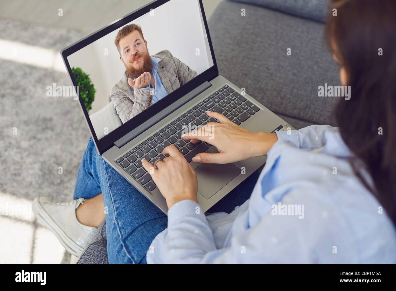 Online date. Online dating at home. A couple gets acquainted using the video chat application in the gadget. Stock Photo