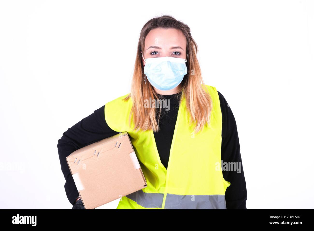postman with yellow giachet worker in the white background Stock Photo