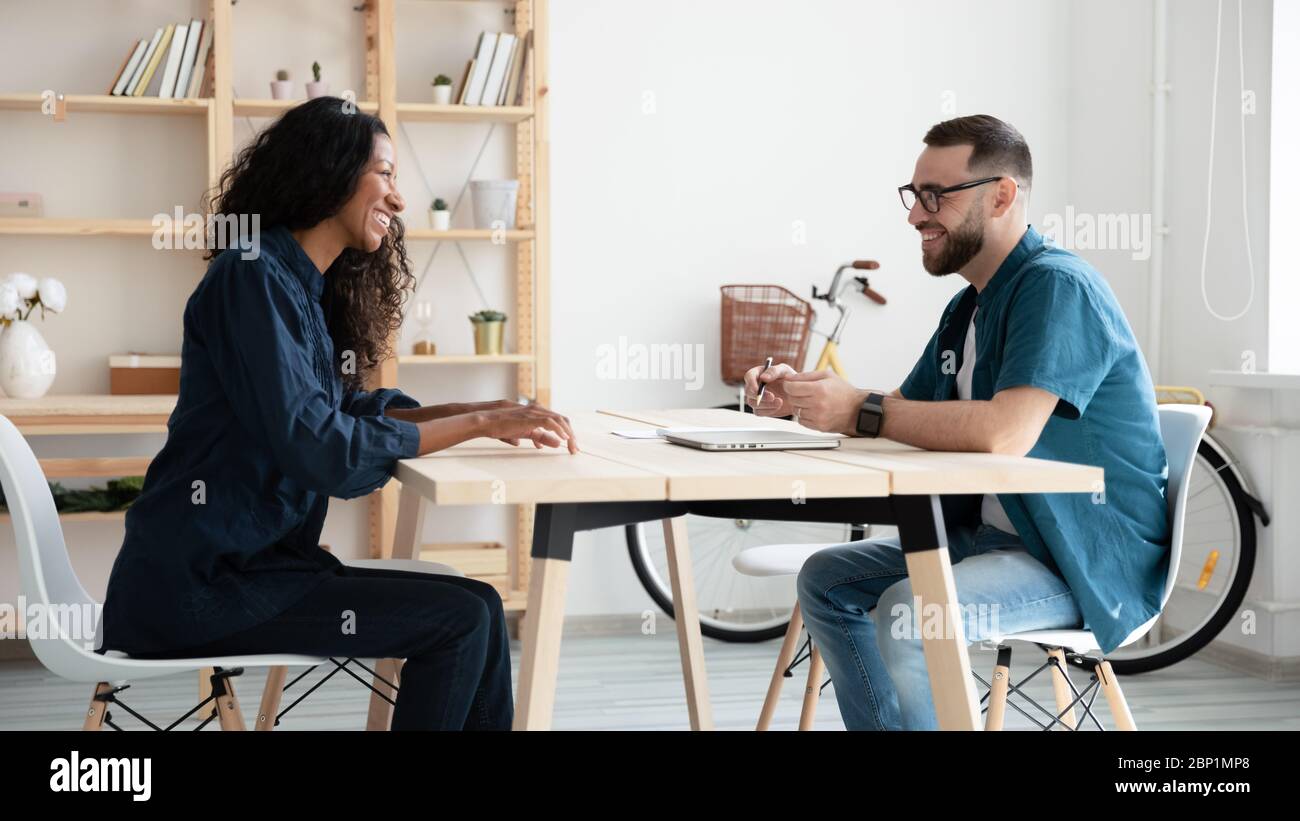 Happy hr manager laughing interviews new african american applicant. Stock Photo