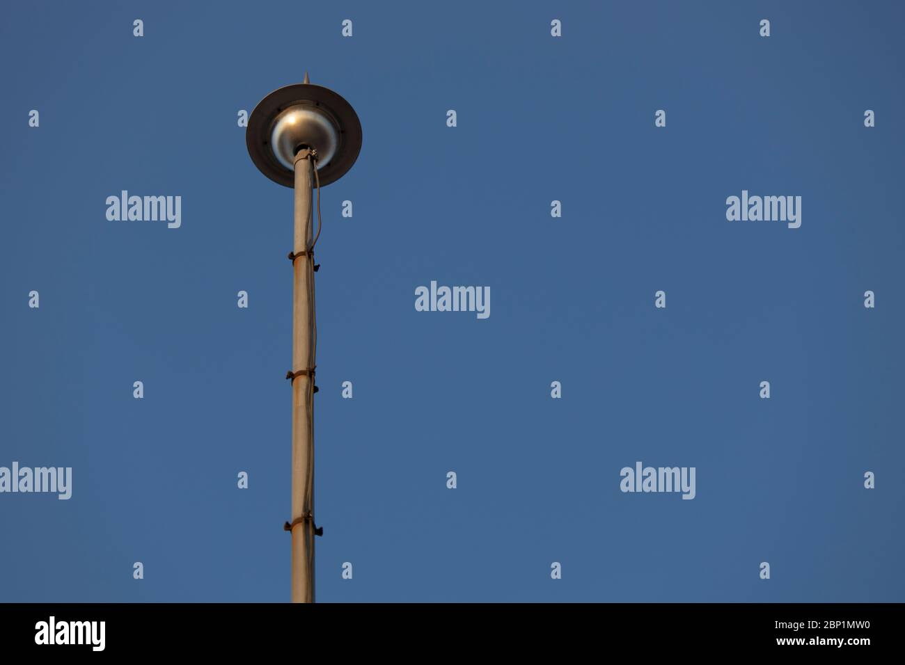 Photo of the top of the lightning rod, background blue sky. Close up. Stock Photo