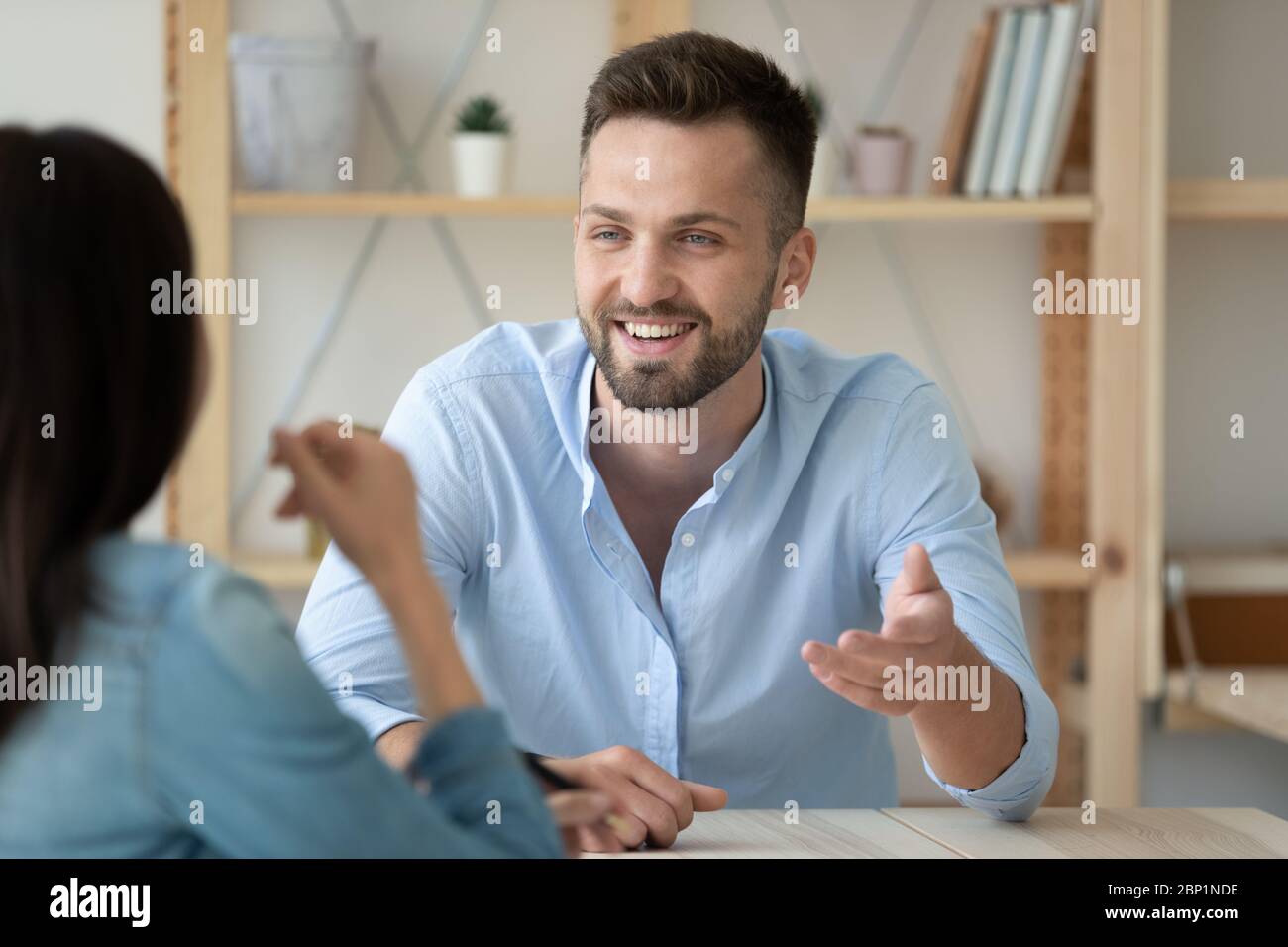Close up smiling male hr manager talking with new applicant. Stock Photo