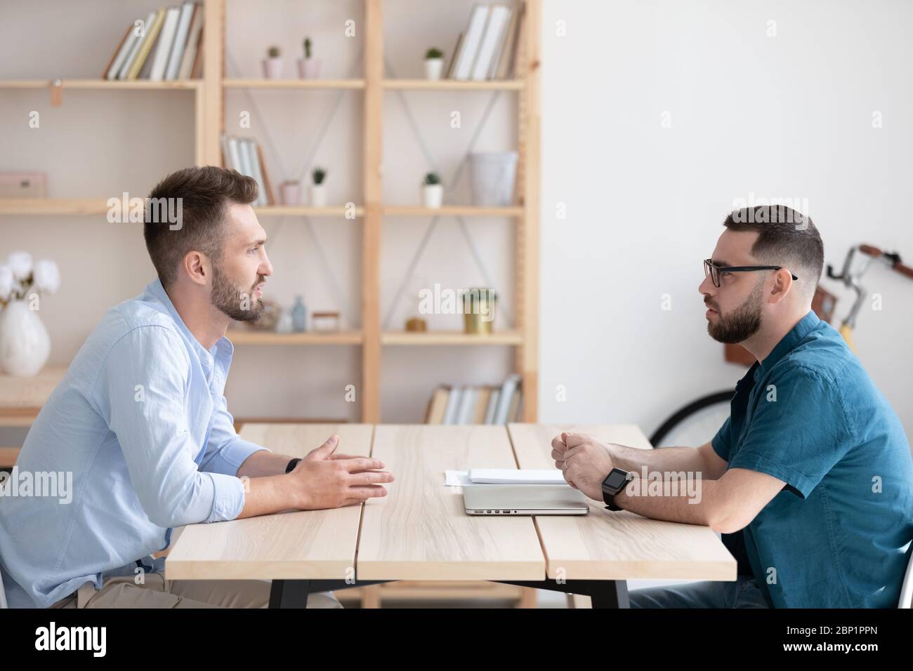 Side view young man applicant introduction himself to hr manager., Stock Photo