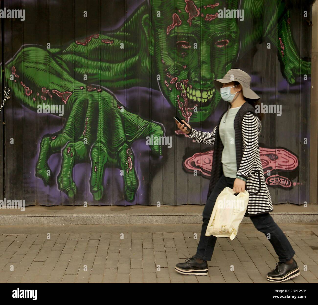 Beijing, China. 17th May, 2020. Chinese continue wearing protective face masks outside as the coronavirus pandemic threat continues in Beijing on Sunday, May 17, 2020. Wuhan, a city of 11 million, where the Covid-19 pandemic originated, reported new cases over the weekend, its first new infections in over a month. China is aggressively investigating the new cluster, announcing a plan to test the entire city in 10 days. Photo by Stephen Shaver/UPI Credit: UPI/Alamy Live News Stock Photo