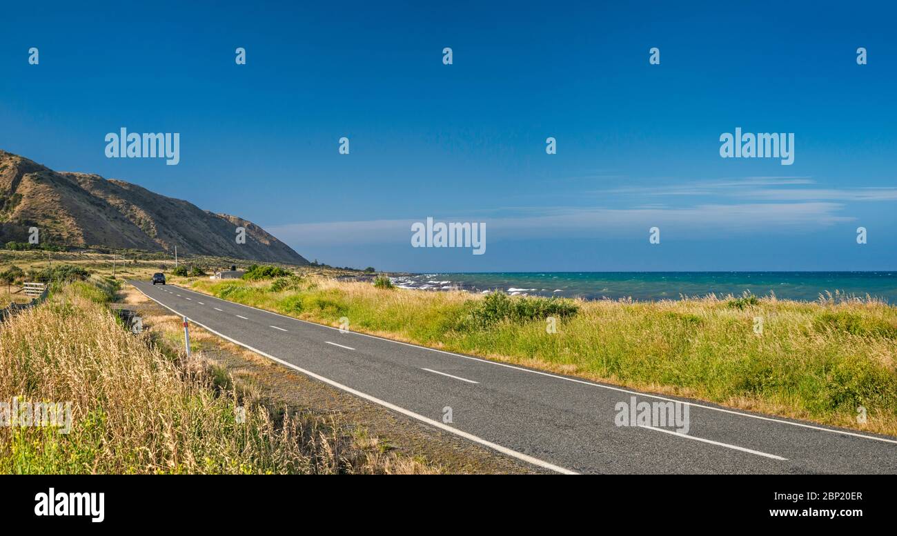 Cape Palliser Road near Te Humenga Point, South Wairarapa Coast, Palliser Bay, Cook Strait, Wellington Region, North Island, New Zealand Stock Photo