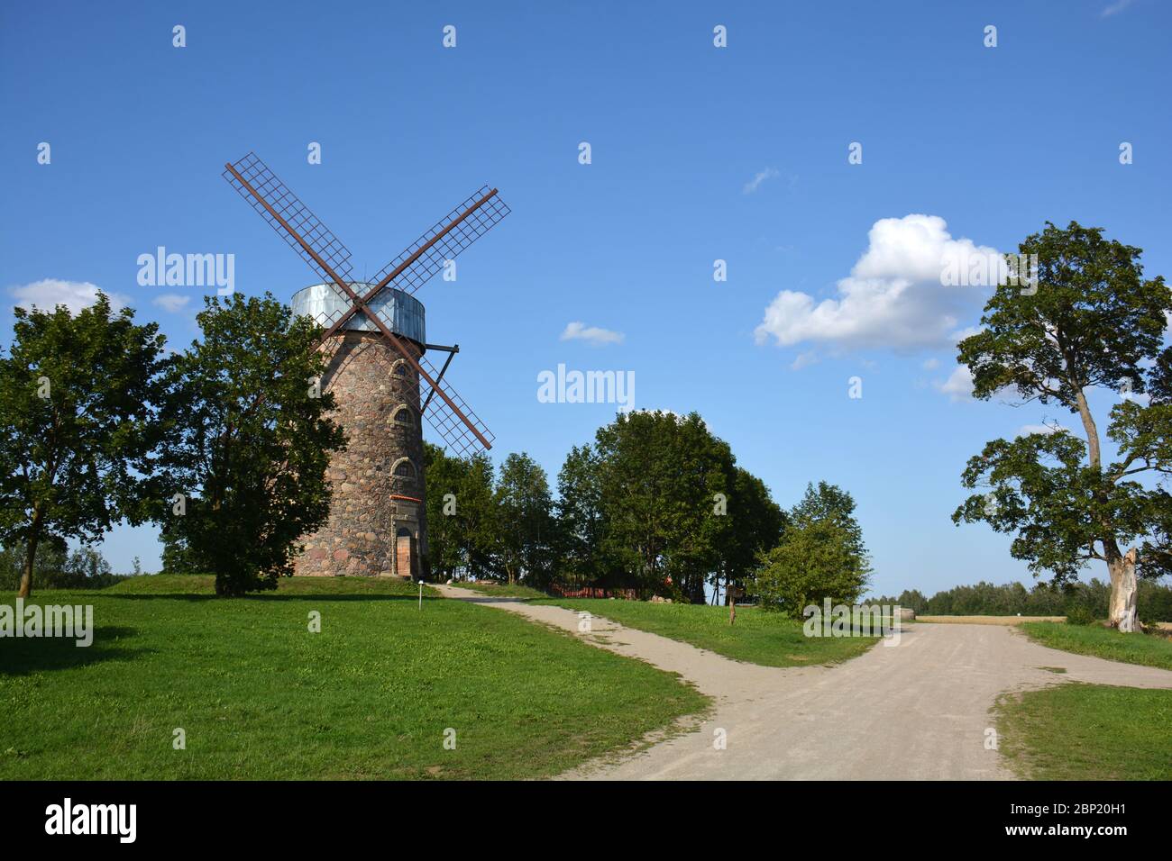 Very beautiful historical restored windmill near gravel road in Lithuania Stock Photo