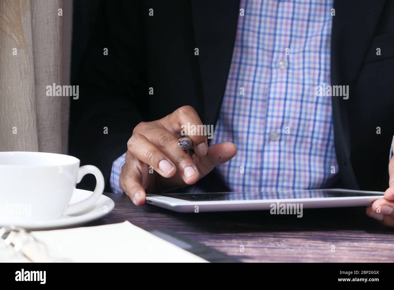 Businessman in suit working on digital tablet  Stock Photo