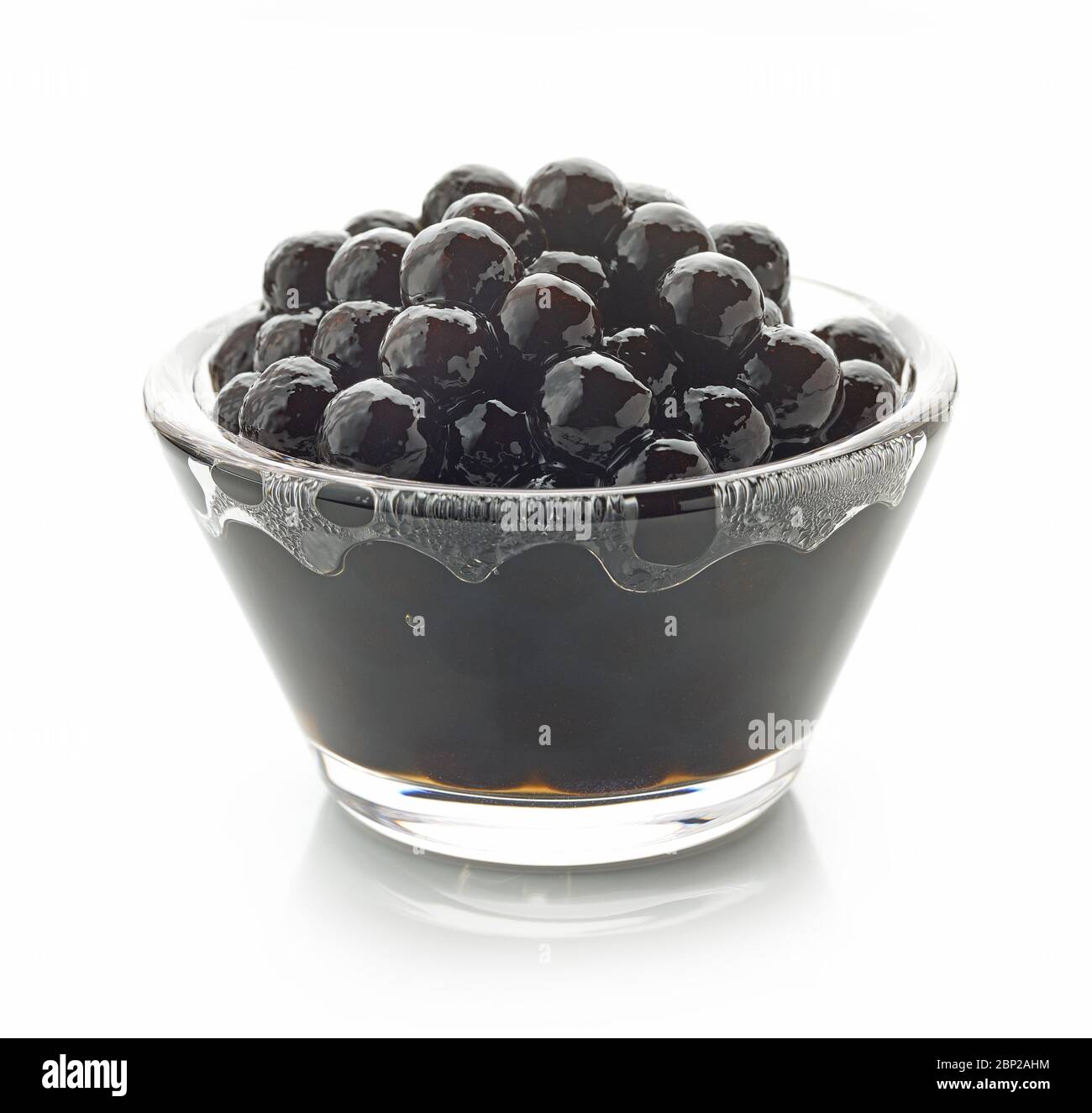 Bowl of black homemade tapioca pearls for bubble tea isolated on white