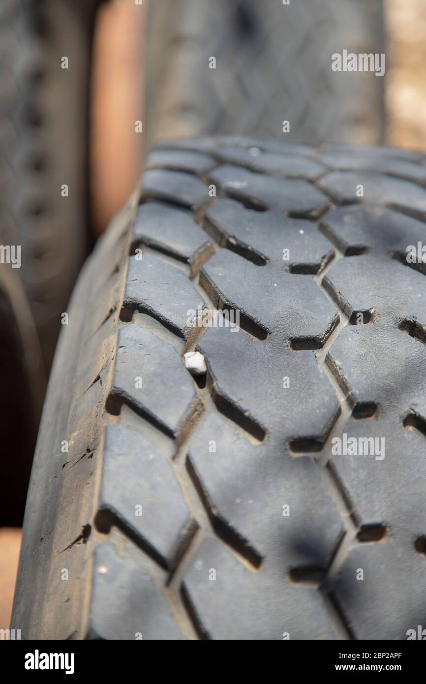a small pebble stuck in the tire tread of a lorry Stock Photo