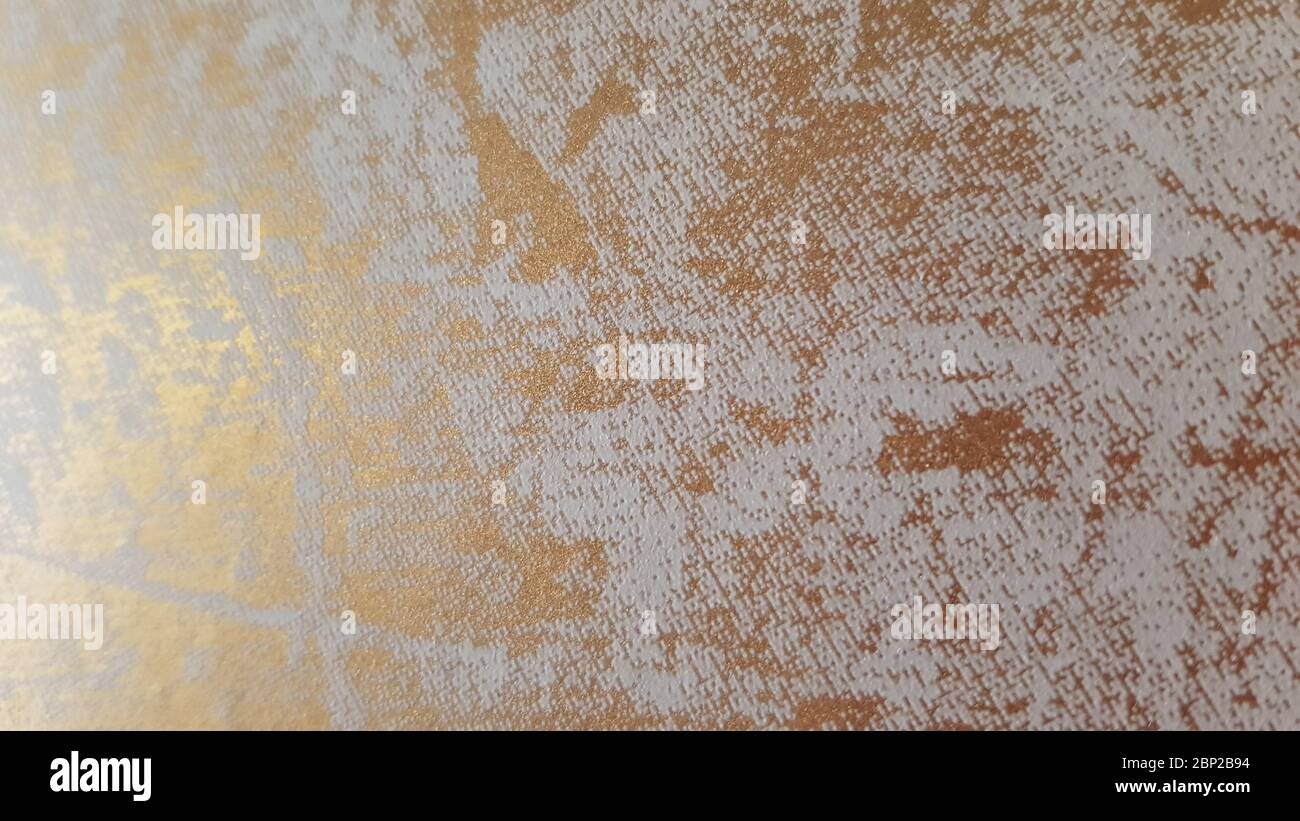 Grungy wall texture with golden marble pattern on grey structure. Abstract interior background with copy space Stock Photo