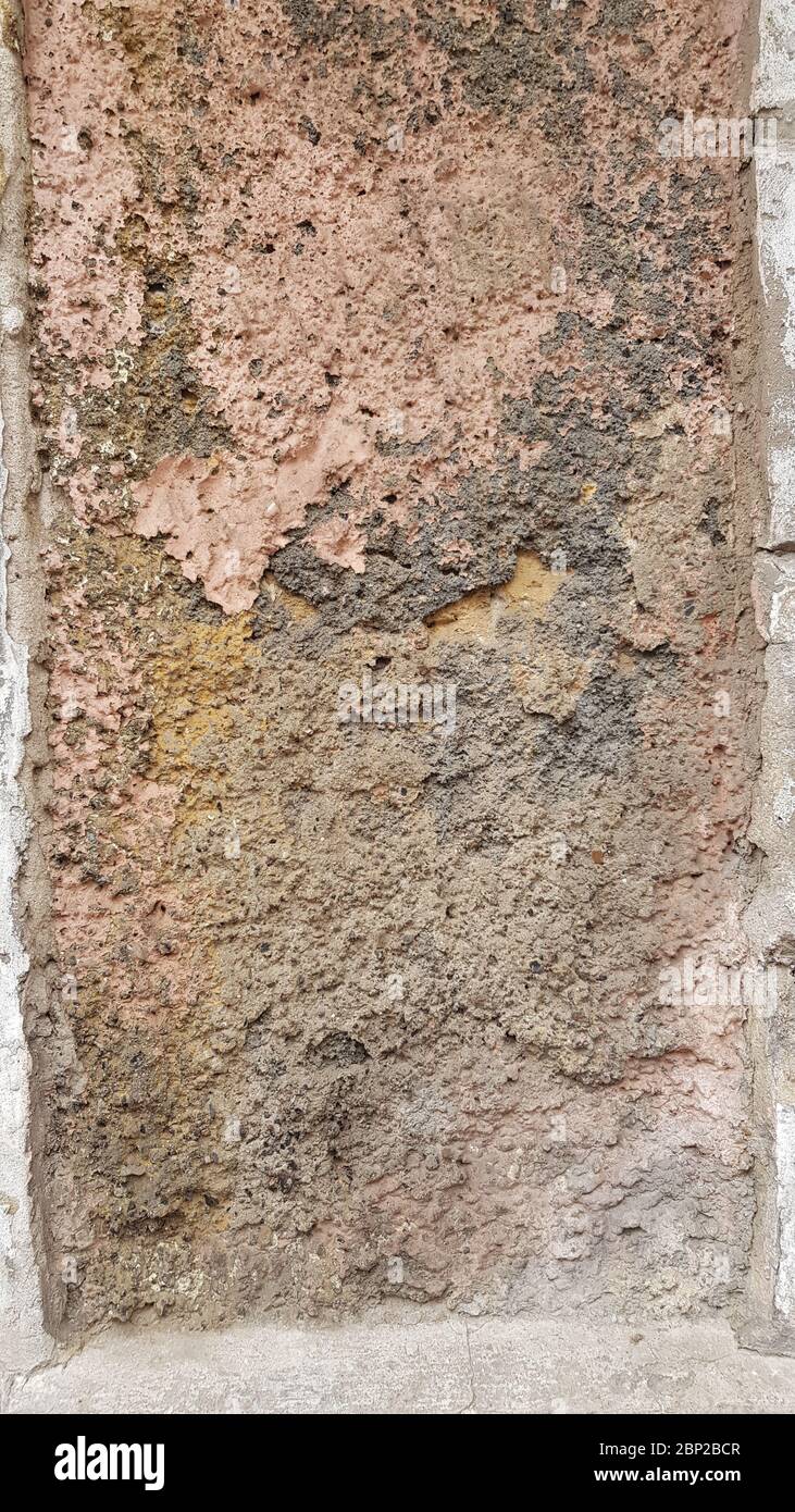 Weathered wall texture closeup with damaged rough brown stone surface ...