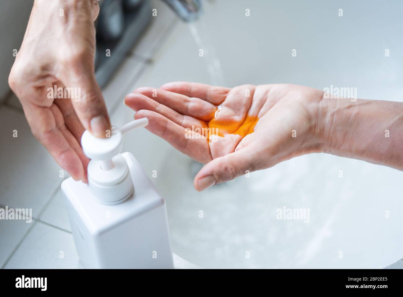 Woman washing her hands. Stock Photo