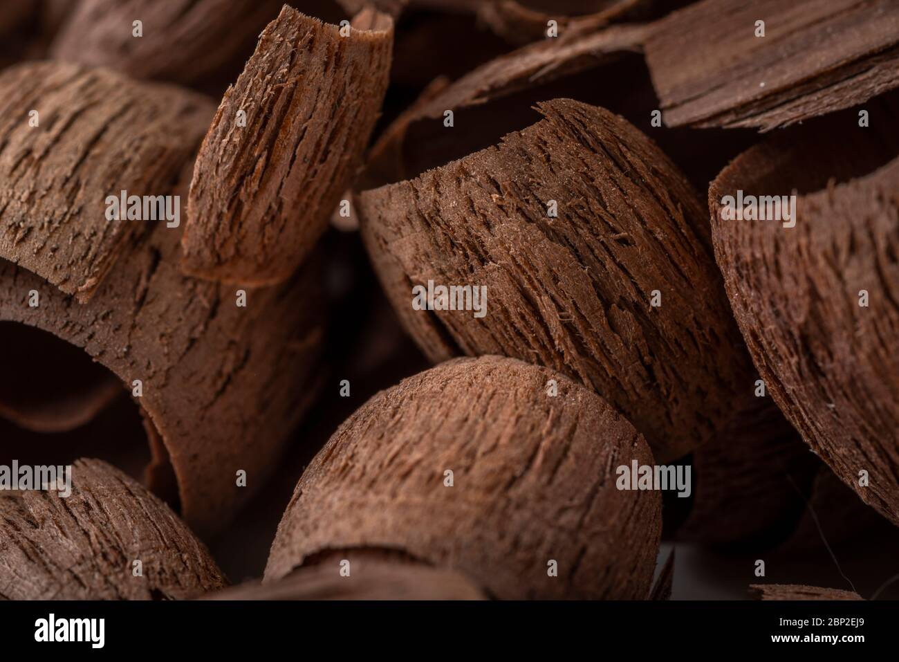 A collection of walnut wood shavings from carving, photographed in a studio Stock Photo Alamy
