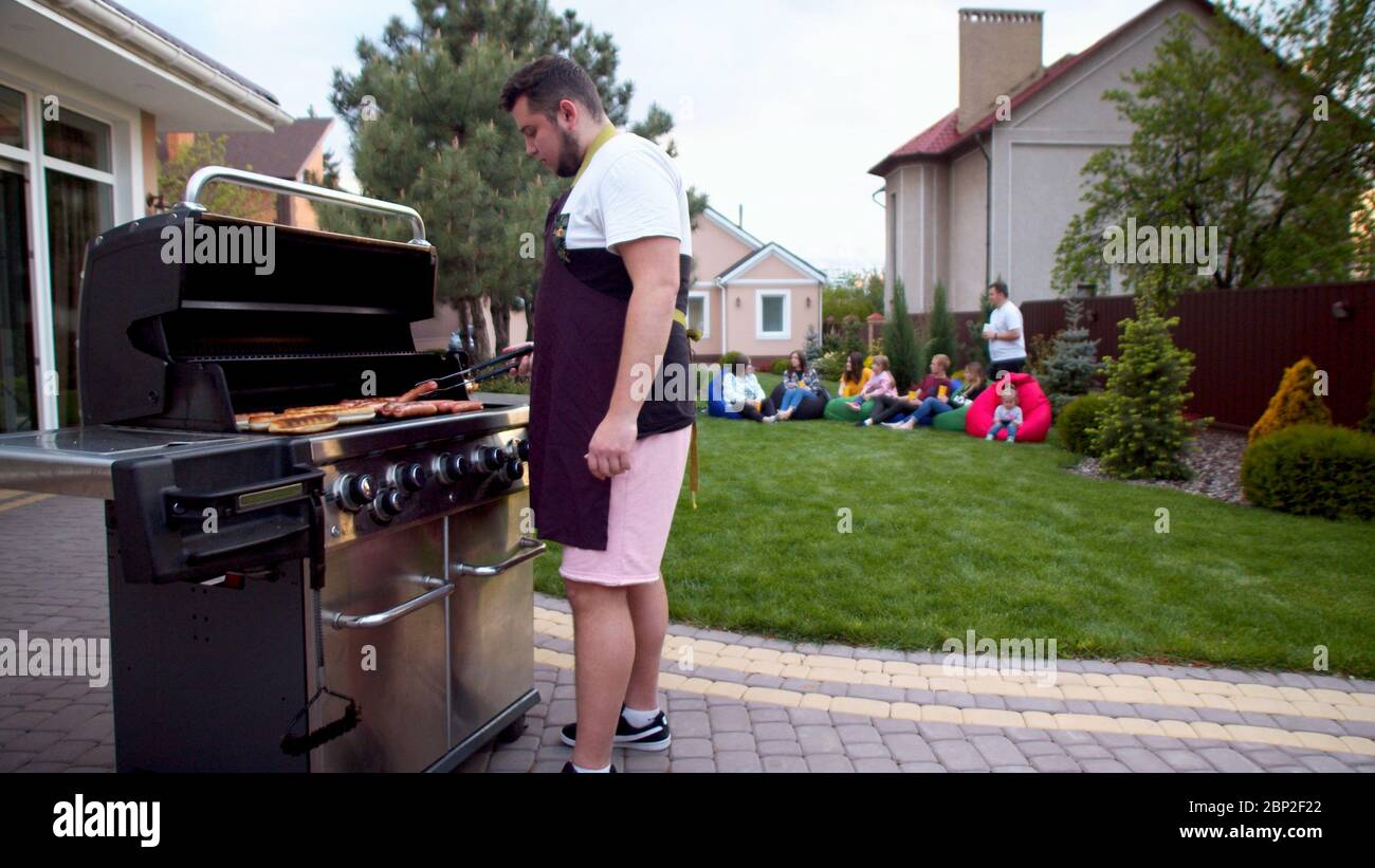 Man serving hot dogs on the back yard Stock Photo Alamy