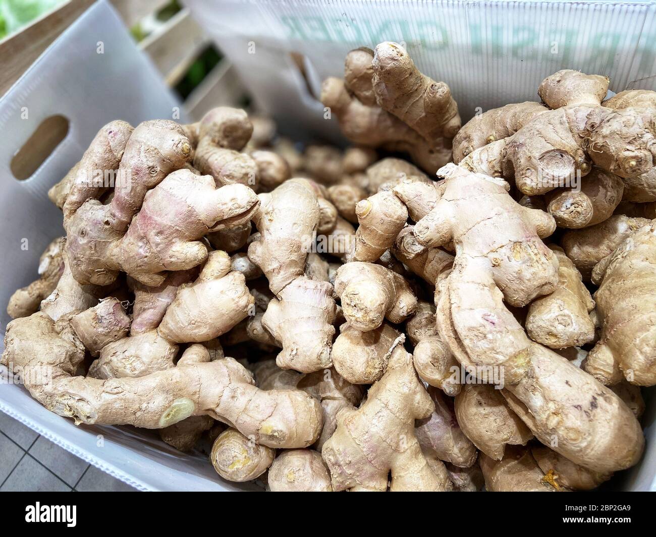 Mobile photo. Ginger root in the tray. Supermarket. Stock Photo
