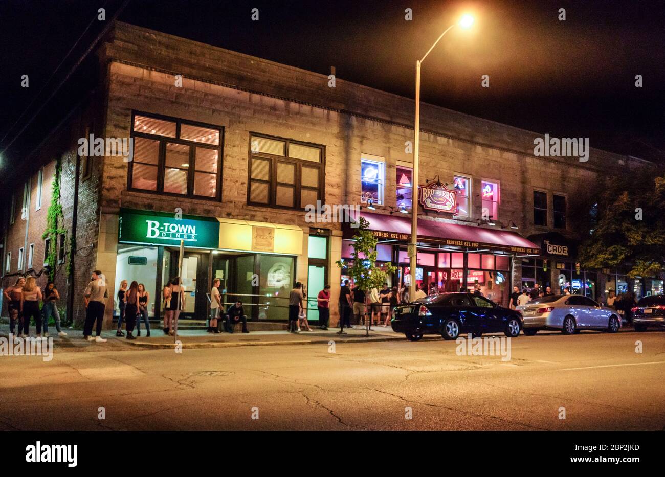 Patrons line up outside Brothers Bar and Grill in downtown Bloomington