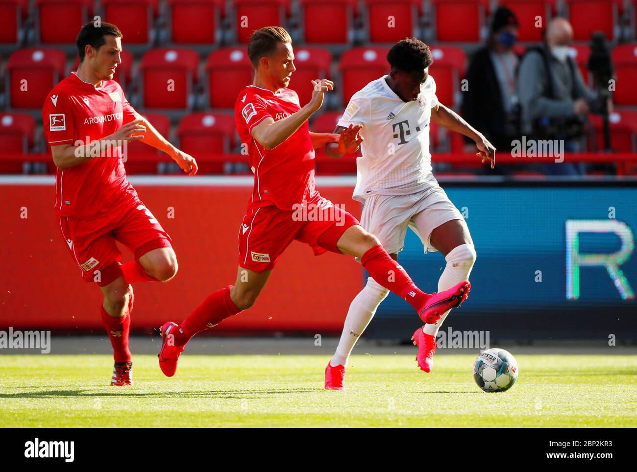 FC Union Berlin's Marcus Ingvartsen in action with Bayern Munich's Alphonso Davies, right, during the German Bundesliga soccer match between Union Berlin and Bayern Munich in Berlin, Germany. Stock Photo