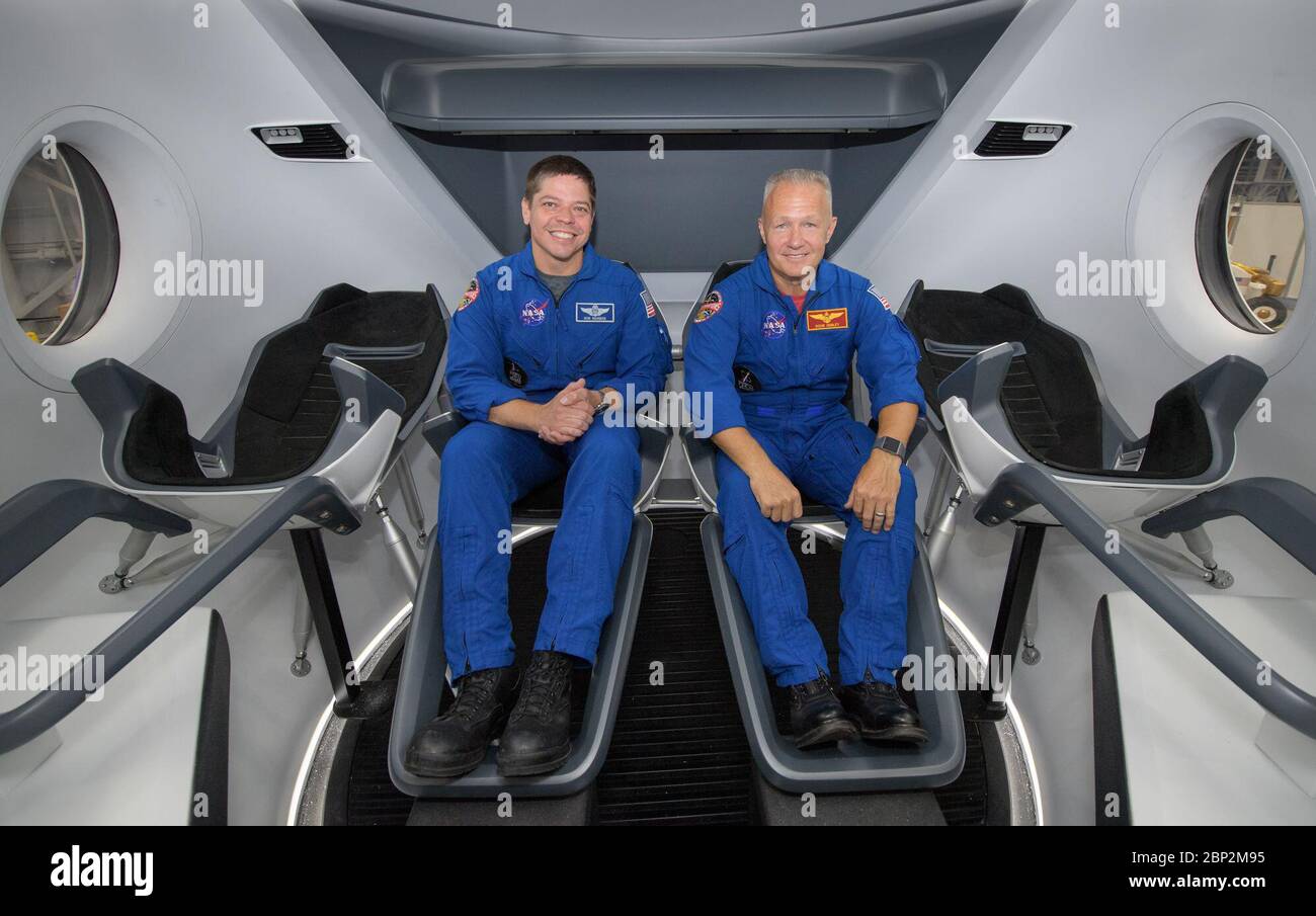 Commercial Crew Program  NASA astronauts Bob Behnken, left, and Doug Hurley, assigned to fly on the first test flight of SpaceX’s Crew Dragon, pose inside a mockup of the spacecraft at NASA’s Johnson Space Center in Houston, Texas on Aug. 2, 2018 ahead of the agency’s announcement of their commercial crew assignment Aug. 3.  Nine U.S. astronauts were selected for commercial crew flight assignments on the first test flights and operational missions for Boeing’s CST-100 Starliner and SpaceX’s Crew Dragon. Stock Photo