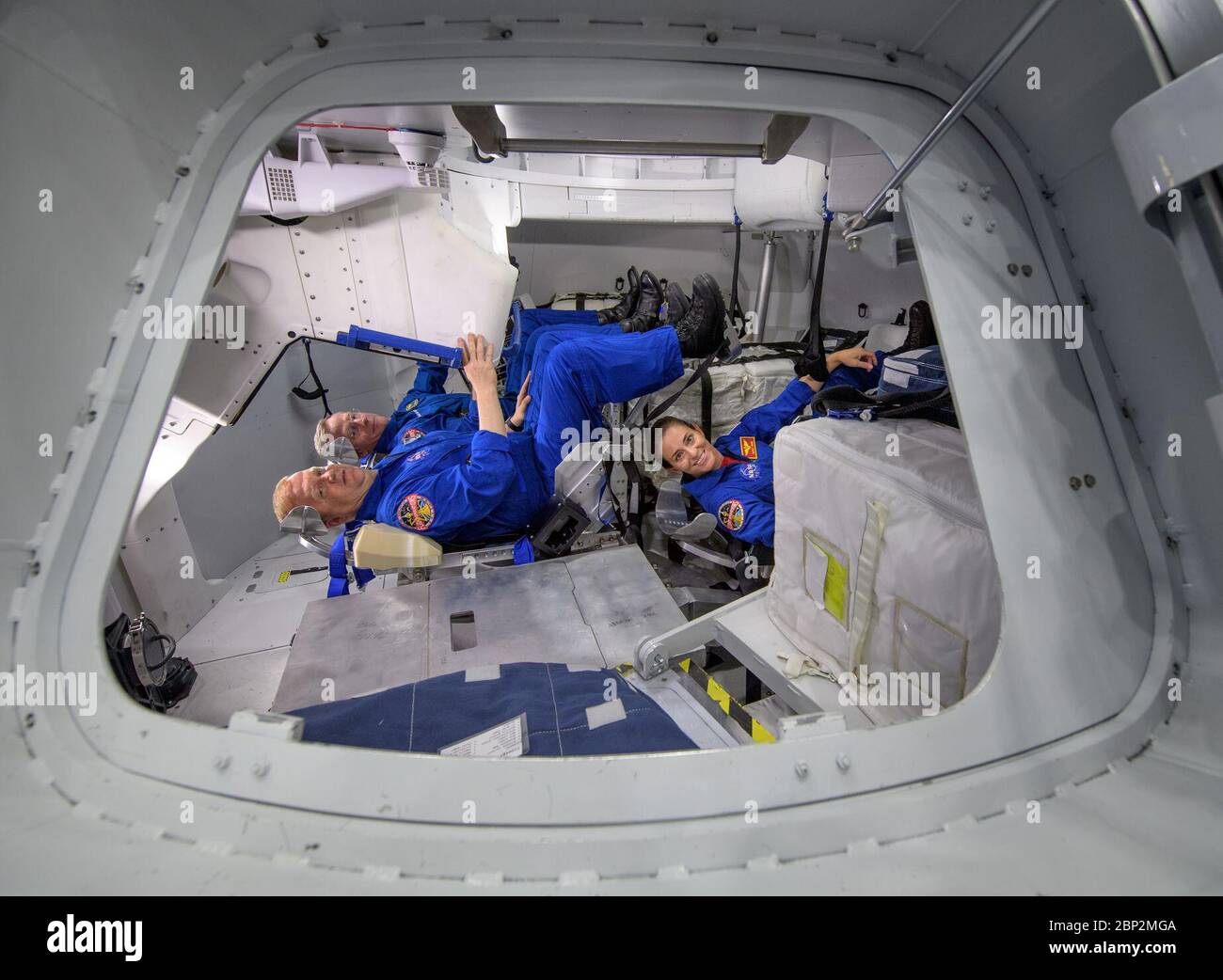 Commercial Crew Program  NASA astronauts Eric Boe, foreground left, and Nicole Mann, foreground right, along with Boeing astronaut Chris Ferguson, background, pose for a photograph inside the Boeing Mockup Trainer at NASA’s Johnson Space Center in Houston, Texas on Aug. 2, 2018 ahead of the commercial crew flight assignments announcement Aug. 3. The three were assigned to launch aboard Boeing’s CST-100 Starliner on the company’s Crew Flight Test targeted for mid-2019 in partnership with NASA’s Commercial Crew Program. Stock Photo