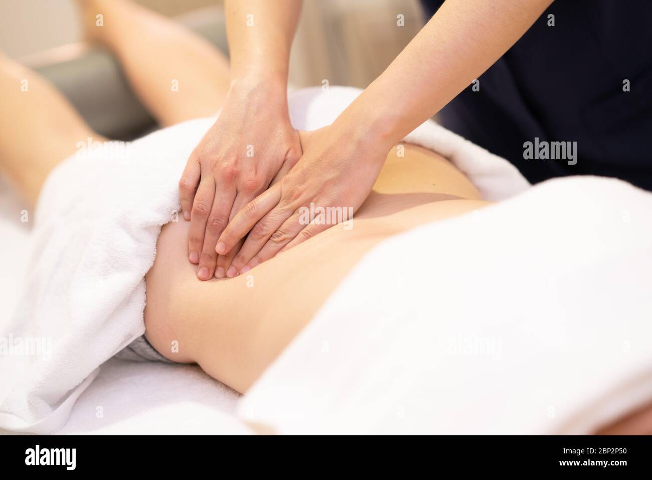 Young woman receiving a back massage in a spa center Stock Photo