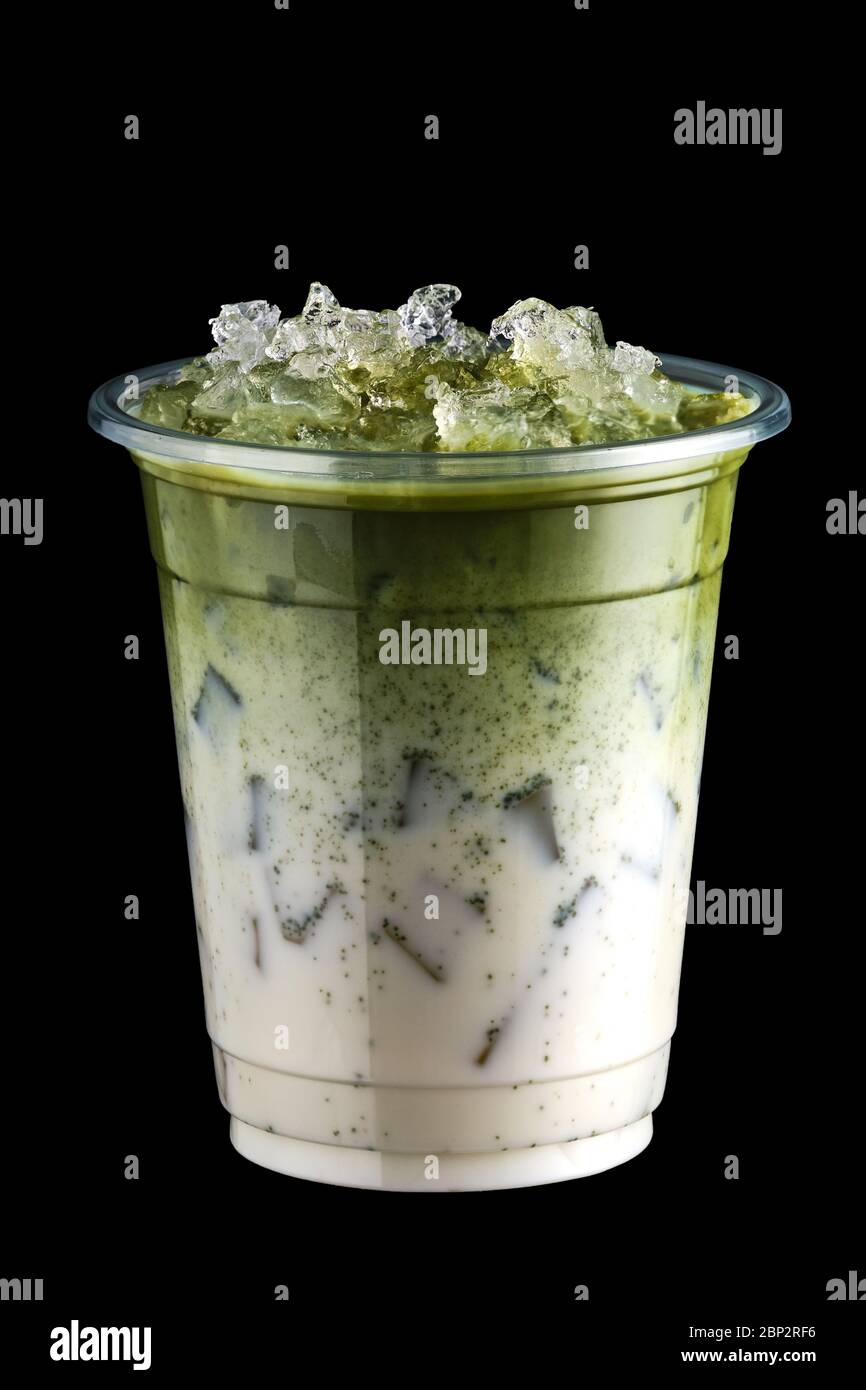 Iced matcha tea and crushed ice in take away cup isolated on black background Stock Photo
