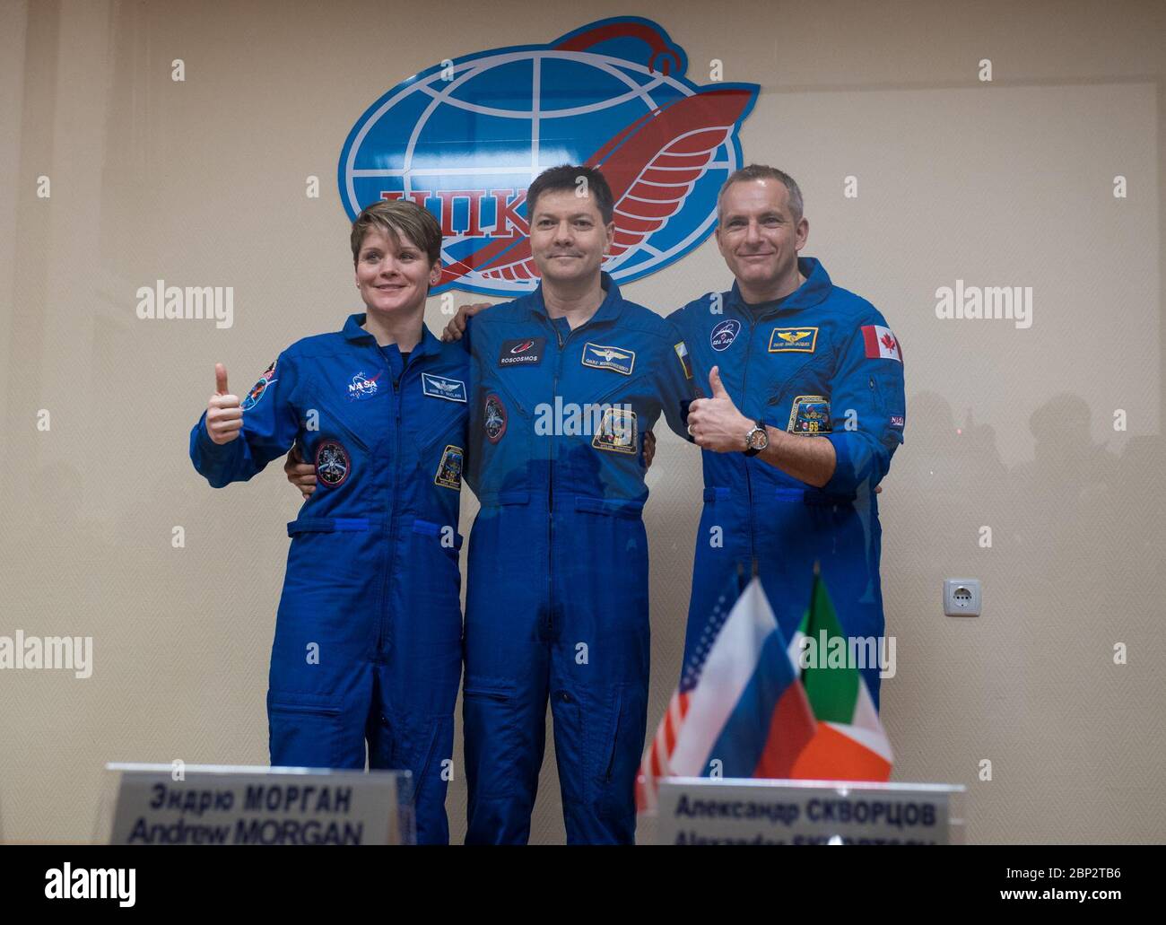 Expedition 58 Press Conference  Expedition 58 prime crew members, left to right, Flight Engineer Anne McClain of NASA, Soyuz Commander Oleg Kononenko of Roscosmos, and Flight Engineer David Saint-Jacques of the Canadian Space Agency (CSA) pose for a photo at the conclusion of a press conference, Sunday, Dec. 2, 2018 at the Cosmonaut Hotel in Baikonur, Kazakhstan. Launch of the Soyuz rocket is scheduled for Dec. 3 and will carry Kononenko, McClain, and Saint-Jacques into orbit to begin their six and a half month mission on the International Space Station. Stock Photo