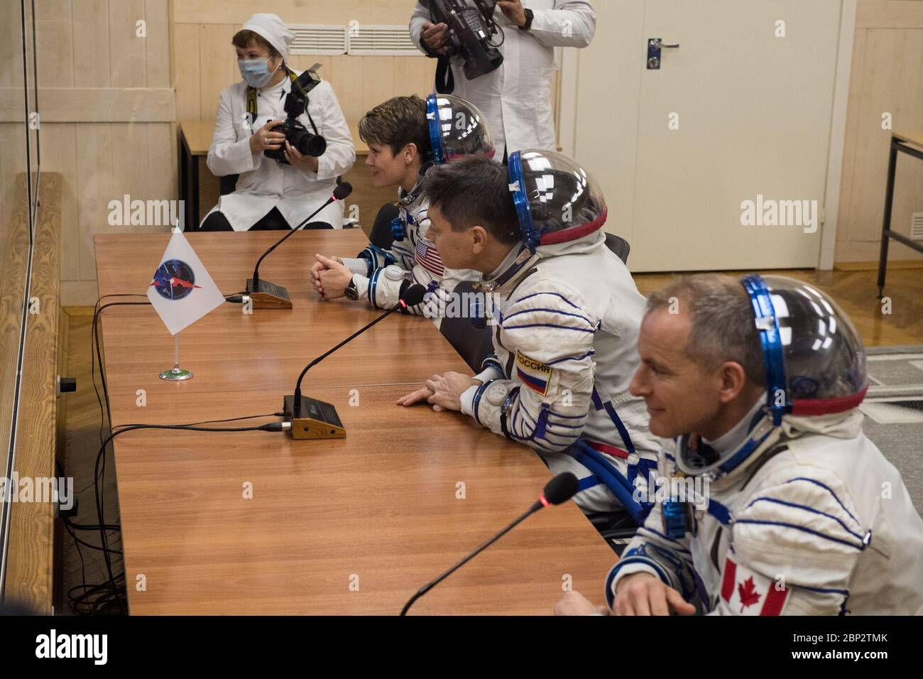 Expedition 58 Pressure Checks  Expedition 58 crew, from top to bottom, Flight Engineer Anne McClain of NASA, Soyuz Commander Oleg Kononenko of Roscosmos, and Flight Engineer David Saint-Jacques of the Canadian Space Agency (CSA) speak to family and friends after having their Russian Sokol suits pressure checked in preparation for their launch aboard the Soyuz MS-11 spacecraft on Monday, Dec. 3, 2018, at the Baikonur Cosmodrome in Kazakhstan. Launch of the Soyuz rocket is scheduled for the same day and will carry Kononenko, Saint-Jacques, and McClain into orbit to begin their six and a half mon Stock Photo