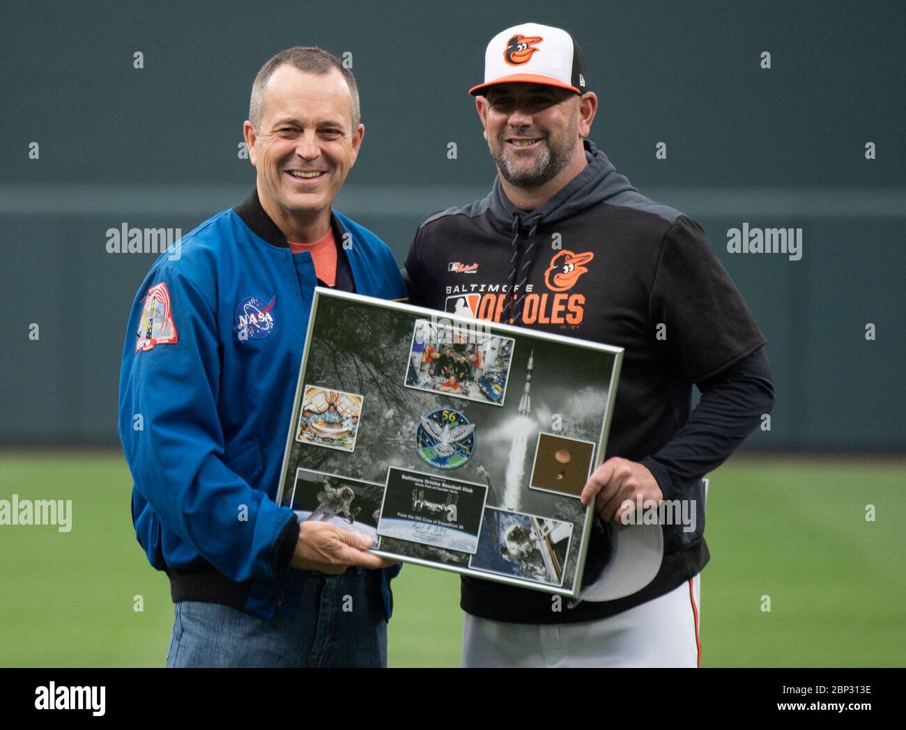 Astronaut Ricky Arnold at Baltimore Orioles Game  NASA astronaut and Maryland native Ricky Arnold presents a montage of images from his mission and a Baltimore Orioles hat that was flown aboard the International Space Station to Baltimore Orioles manager Brandon Hyde before the Tampa Bay Rays take on the Baltimore Orioles, Saturday, May 4, 2019 at Camden Yards in Baltimore, Md. During Arnold’s 197 days onboard the International Space Station, as part of Expeditions 55 and 56, he ventured outside the space station on three spacewalks in addition to conducting numerous experiments and educationa Stock Photo