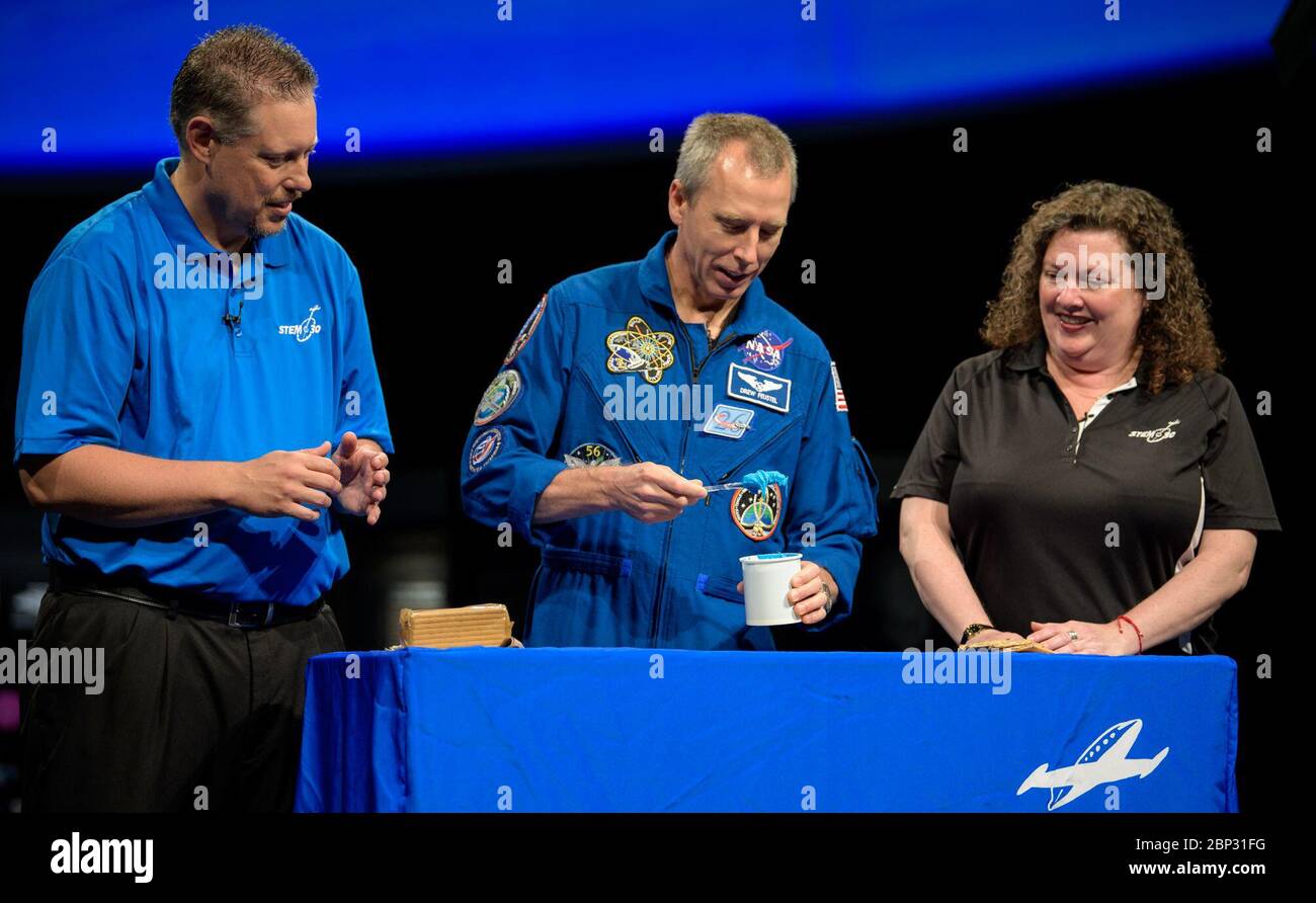 Astronaut Drew Feustel at NASM  NASA astronaut Drew Feustel, center, uses frosting and graham crackers to represent the layers of Earths crust while taping a segment of STEM in 30 with Marty Kelsey, left, and Beth Wilson, right, Thursday, May 9, 2019 at the Smithsonian’s National Air and Space Museum in Washington, DC. Feustel most recently spent 197 days living and working onboard the International Space Station as part of Expedition 55 and as commander of Expedition 56. Feustel ventured outside the space station on three spacewalks, moving him up to second among U.S. spacewalkers with a cumu Stock Photo