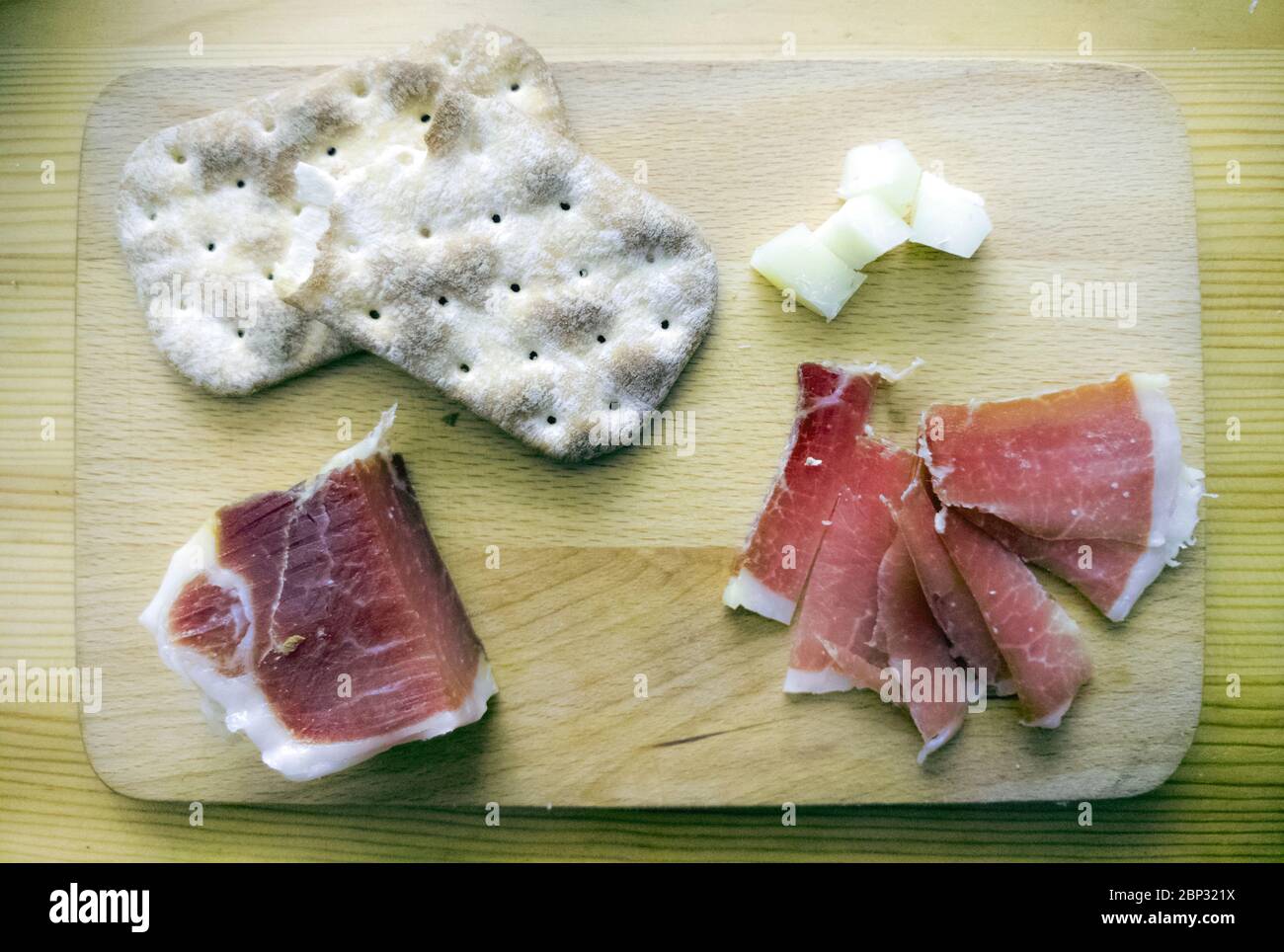 Tapa bar in Spain serrano ham and manchego cheese serve in a wood board ...