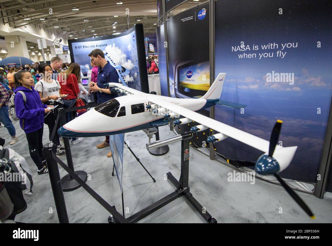 2018 USA Science and Engineering Festival   Attendees listen to a NASA staff member speak about the X-57, a research aircraft powered by 14 electric motors, during Sneak Peek Friday at the USA Science and Engineering Festival, Friday, April 6, 2018 at the Walter E. Washington Convention Center in Washington, DC.  The festival is open to the public April 7-8. Stock Photo