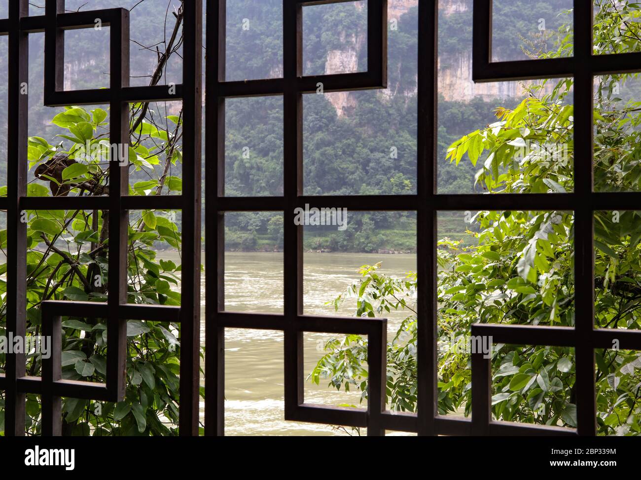 An amazing view of the Yangtze river in China from an ornate wooden window like panel. Stock Photo