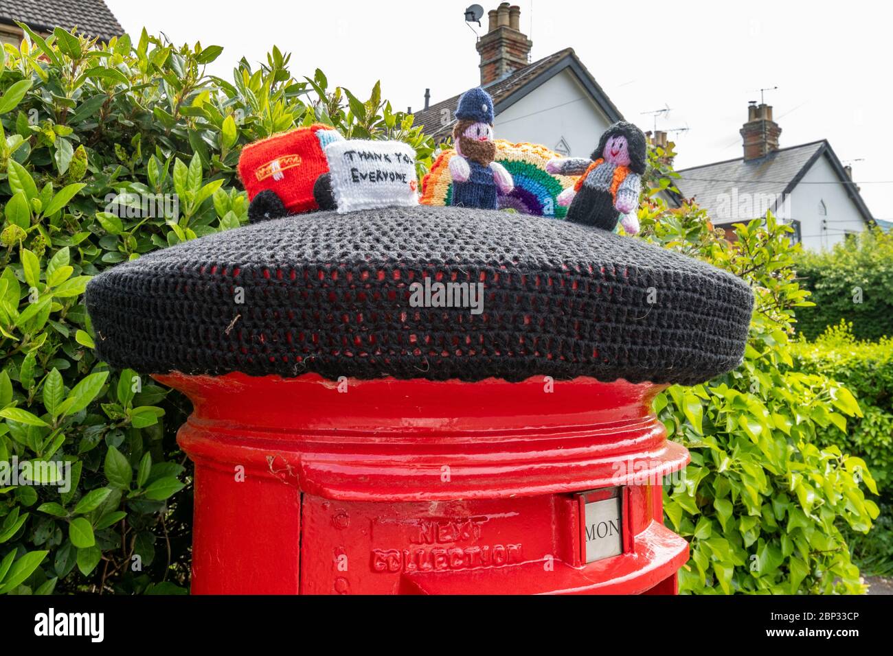 Knitted characters representing key workers on top of a post box in West End village, Surrey, UK, during the 2020 coronavirus covid-19 pandemic Stock Photo