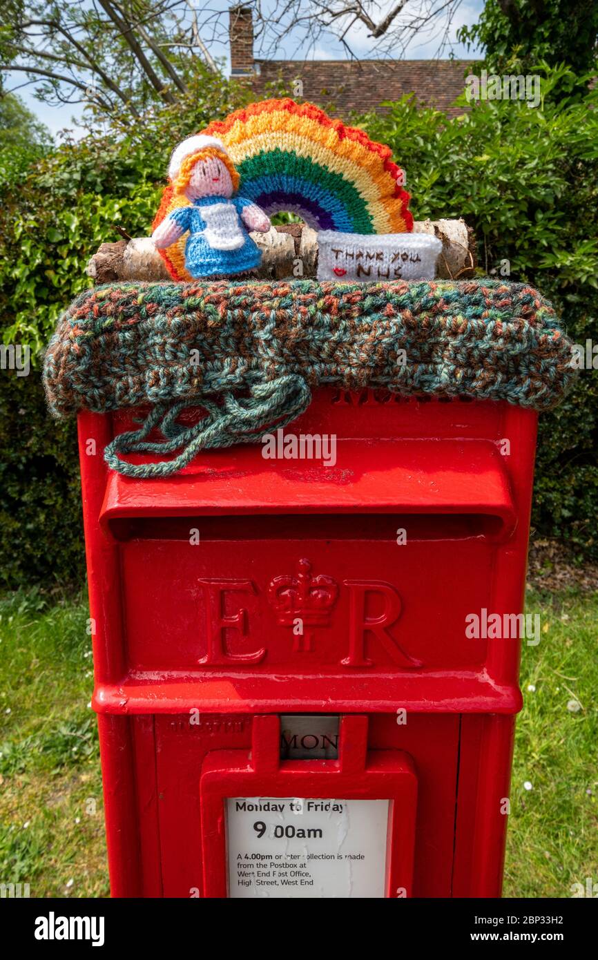 Knitted character representing a nurse on top of a post box in West End village, Surrey, UK, during the 2020 coronavirus covid-19 pandemic Stock Photo