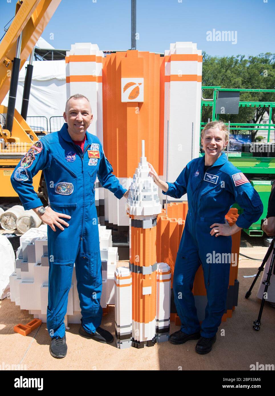 Apollo 11 50th Anniversary Celebration  NASA astronaut Randy Bresnik, left, and NASA astronaut candidate, Zena Cardman, pose for a photo with the soon to be 20 ft. model of the Space Launch System (SLS) made out of LEGOs, at the Apollo 11 50th Anniversary celebration on the National Mall, Friday, July 19, 2019 in Washington. Apollo 11 was the first mission to land astronauts on the Moon and launched on July 16, 1969 with astronauts Neil Armstrong, Michael Collins, and Buzz Aldrin. Stock Photo