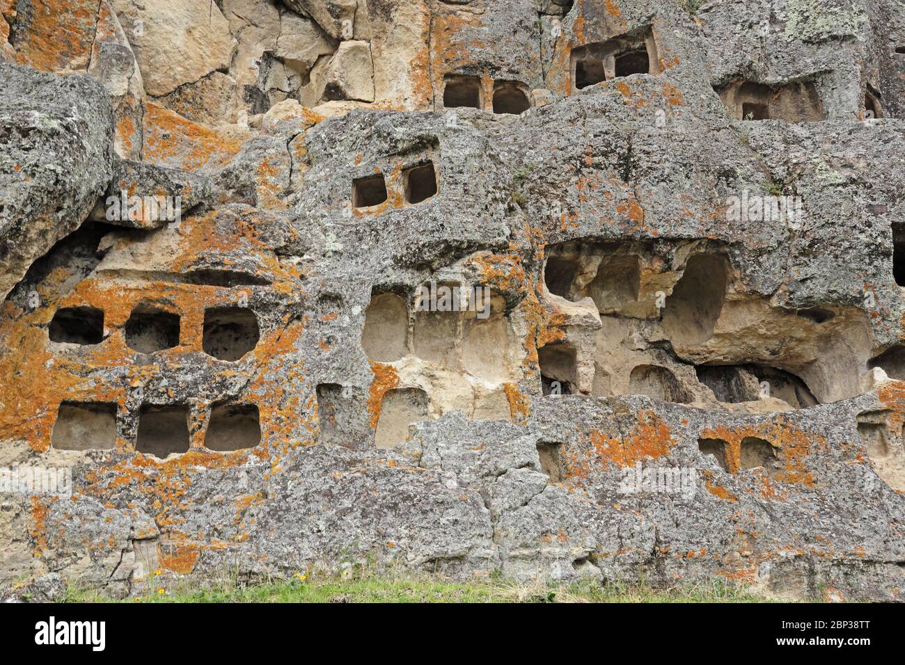 crypts cut into the cliff face  Otuzco archeological site, near Cajamarca, Peru               March Stock Photo