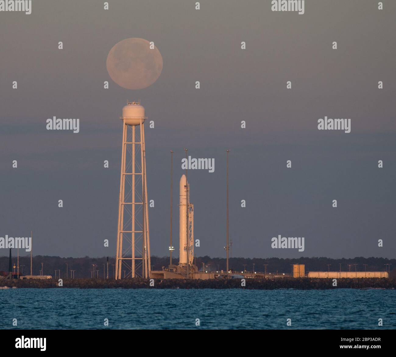 Northrop Grumman Antares CRS-13 Prelaunch A Northrop Grumman Antares rocket carrying a Cygnus resupply spacecraft is seen at sunrise as the Moon sets on Pad-0A, Sunday, Feb. 9, 2020, at NASA's Wallops Flight Facility in Virginia. Northrop Grumman’s 13th contracted cargo resupply mission with NASA to the International Space Station will deliver more than 7,500 pounds of science and research, crew supplies and vehicle hardware to the orbital laboratory and its crew. The CRS-13 Cygnus spacecraft is named after the first African American astronaut, Major Robert Henry Lawrence Jr.. Stock Photo