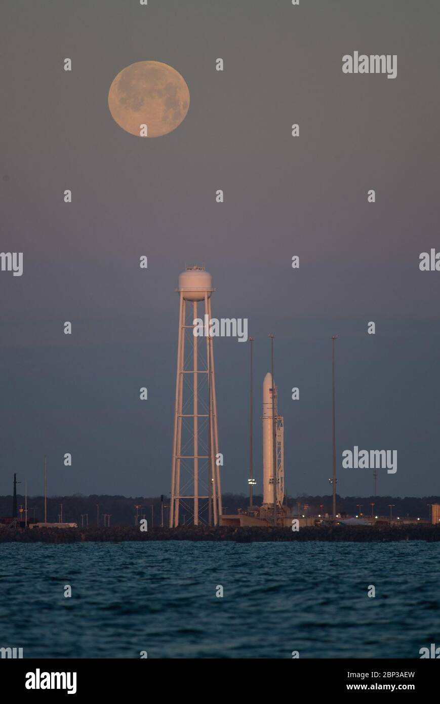 Northrop Grumman Antares CRS-13 Prelaunch  A Northrop Grumman Antares rocket carrying a Cygnus resupply spacecraft is seen at sunrise as the Moon sets on Pad-0A, Sunday, Feb. 9, 2020, at NASA's Wallops Flight Facility in Virginia. Northrop Grumman’s 13th contracted cargo resupply mission with NASA to the International Space Station will deliver more than 7,500 pounds of science and research, crew supplies and vehicle hardware to the orbital laboratory and its crew. The CRS-13 Cygnus spacecraft is named after the first African American astronaut, Major Robert Henry Lawrence Jr.. Stock Photo