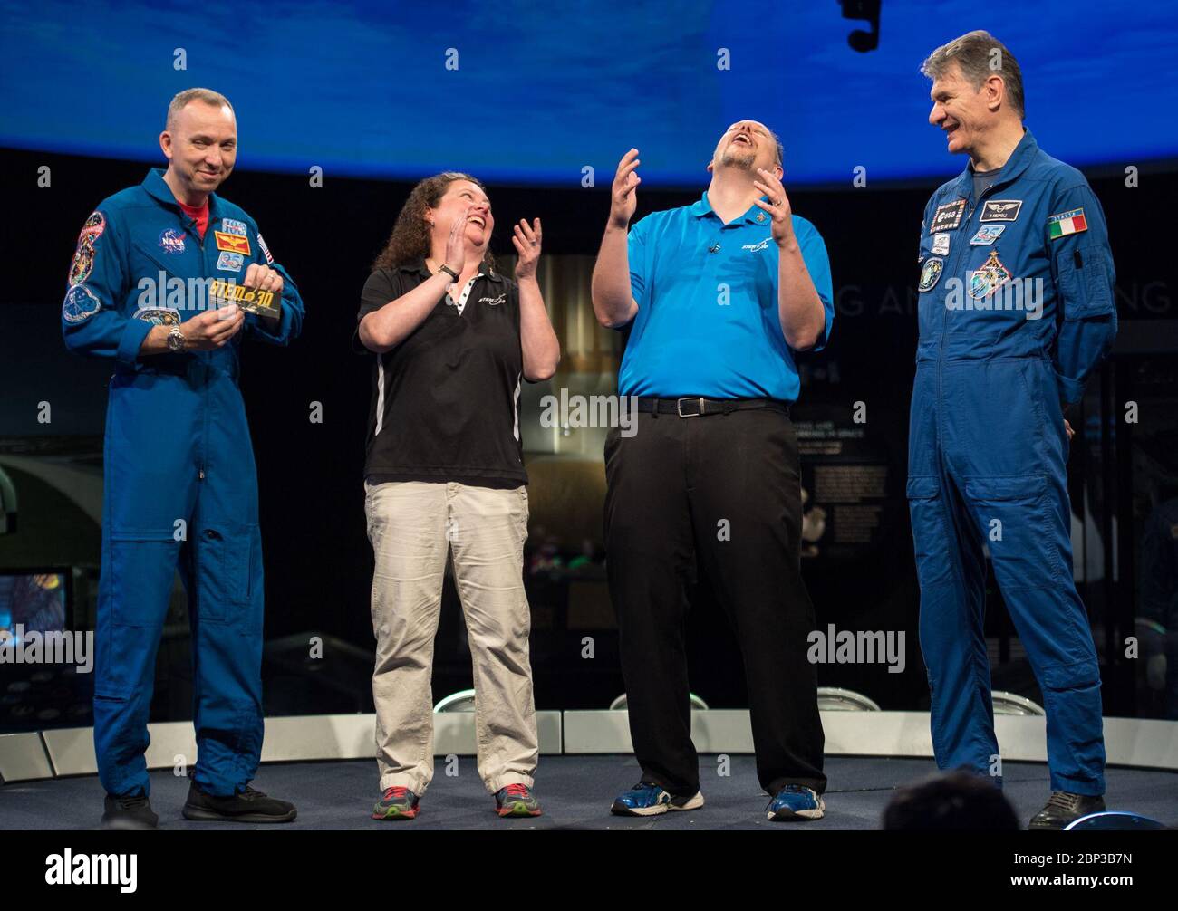 Astronauts Bresnik and Nespoli at National Air and Space Museum  NASA astronaut Randy Bresnik, left, and ESA astronaut Paolo Nespoli, right, present Marty Kelsey, second from right, and Beth Wilson, of STEM in 30 with their bookmark that flew in space onboard the International Space Station during expeditions 52/53, Thursday, May 10, 2018 at the Smithsonian National Air and Space Museum in Washington. Stock Photo