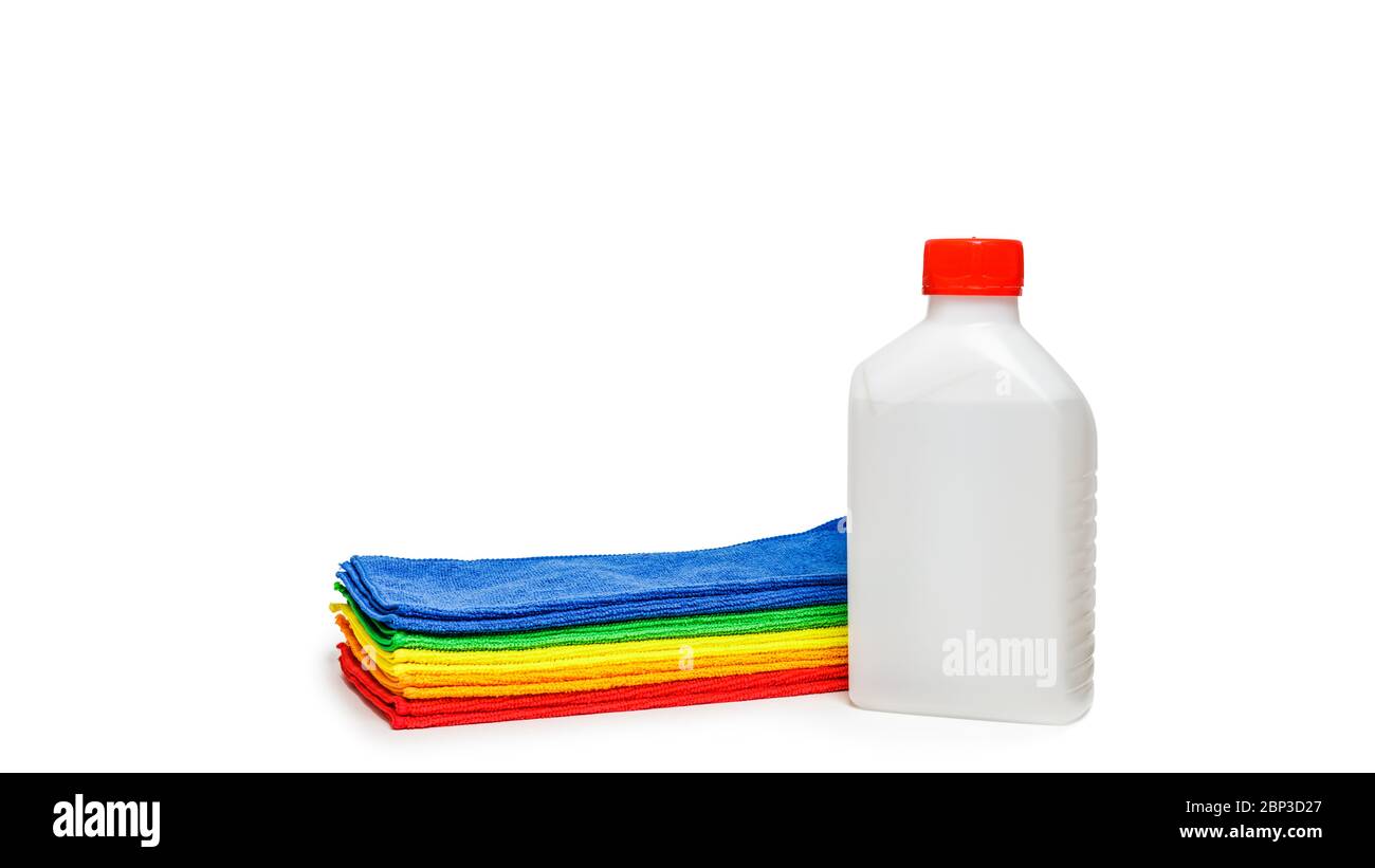 Multi-colored microfiber towels and a bottle of disinfectant isolated over white background. Stock Photo
