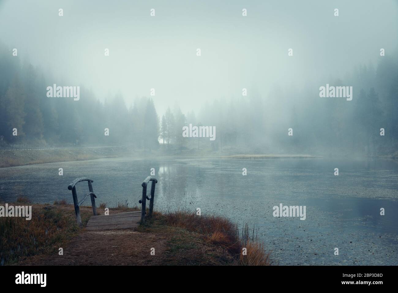 Dolomites natural landcape with lake in fog in North Italy Stock Photo ...