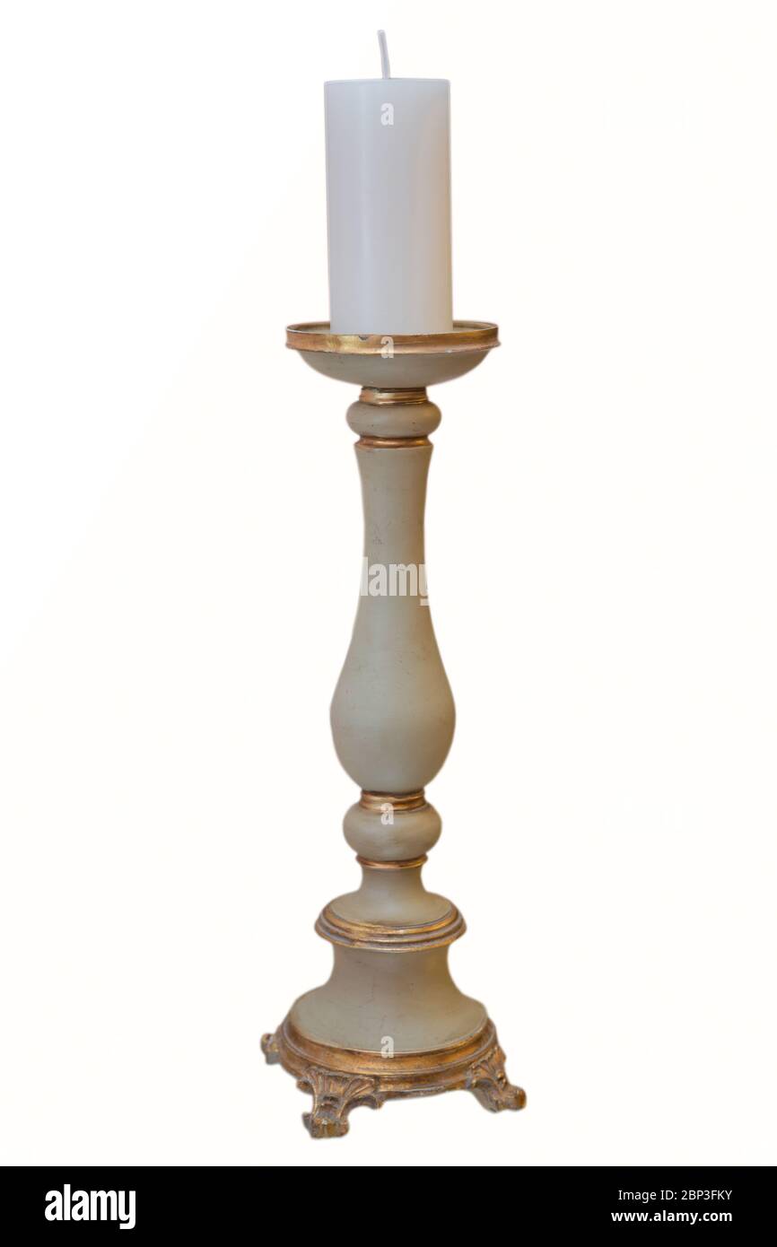 Old brass candle holder on white background . White candle . Brass