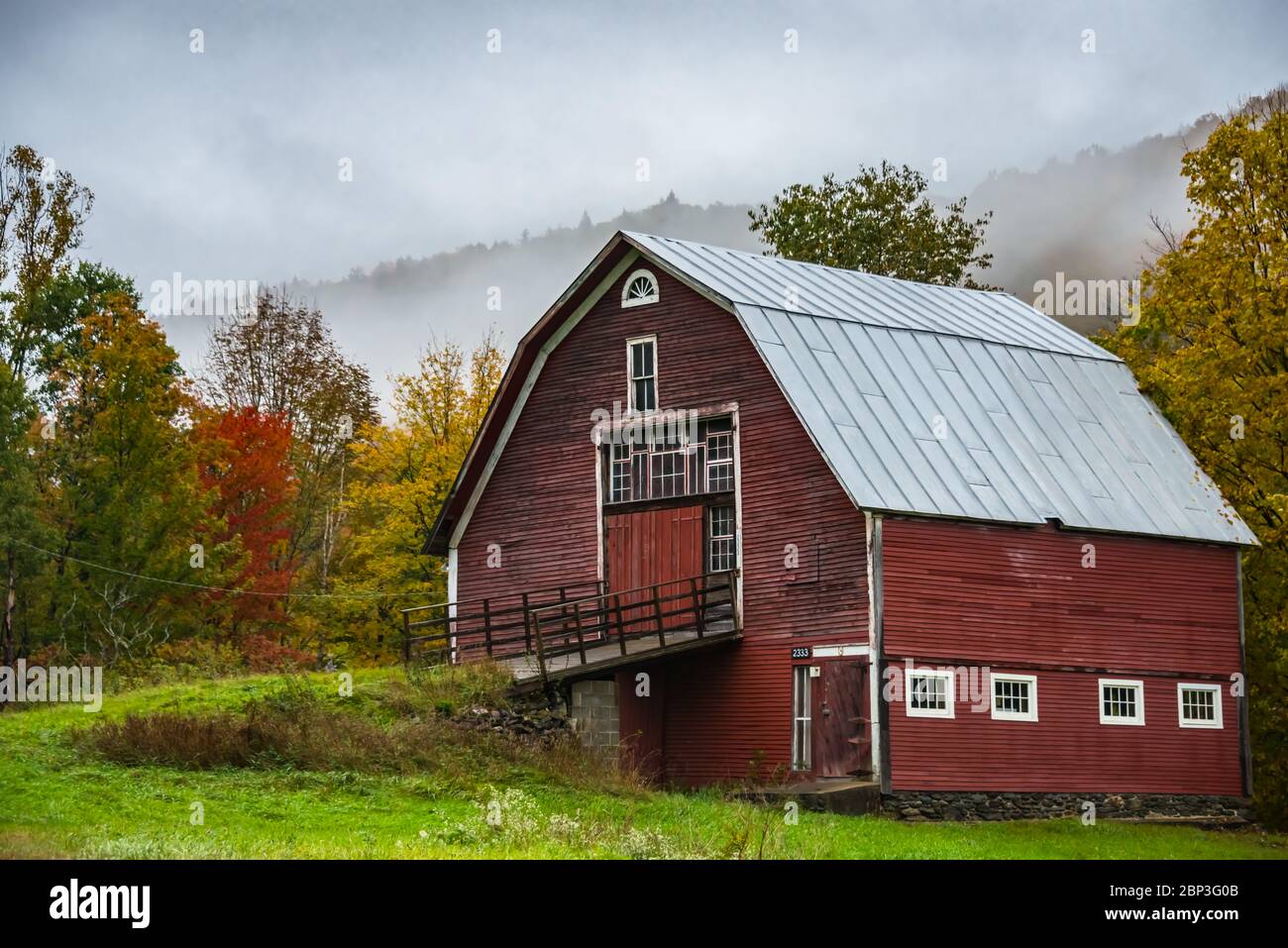 Old Wooden Red Barn with Fall Foliage, Hancock, Vermont Stock Photo