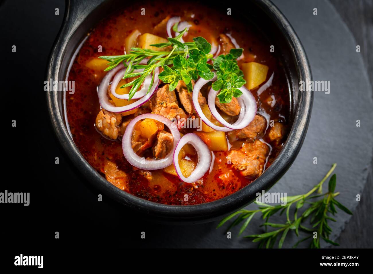 Traditional Hungarian goulash - stew of meat and vegetables with onions and herbs Stock Photo