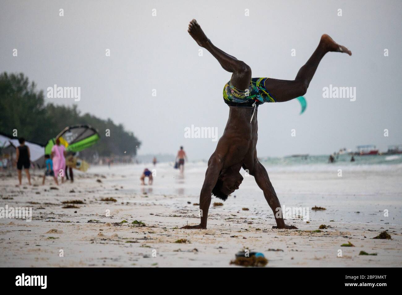 Young Attractive Muscular and Strong Athletic Black African Man at the White Sand Beach Training Body Calisthenics Stock Photo