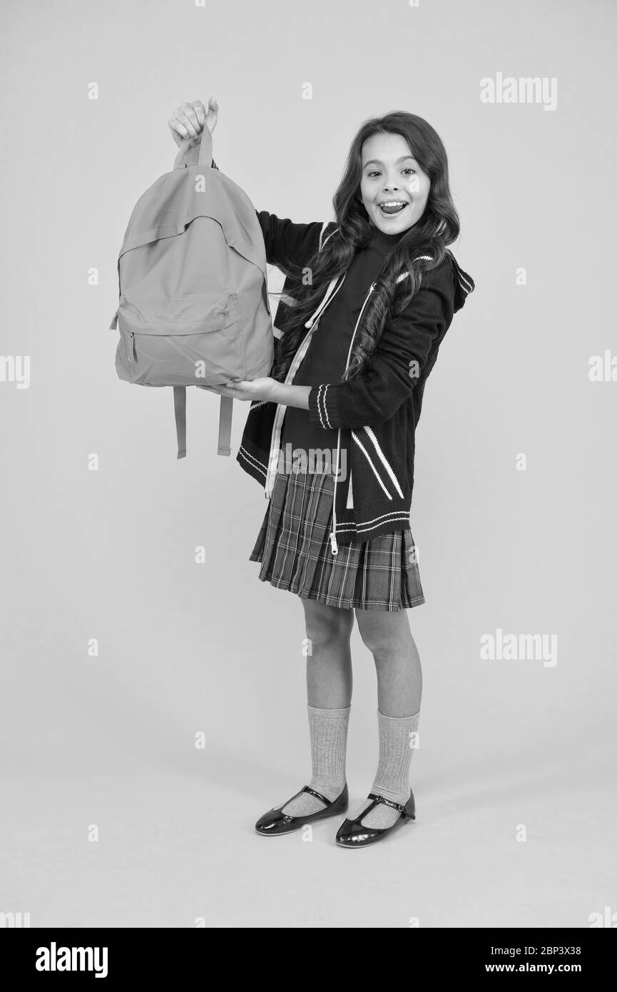 go study to england. learning languages. british school in england. vacation in great britain. travel concept. small girl uniform hold backpack. kid with english flag on jacket. childhood happiness. Stock Photo