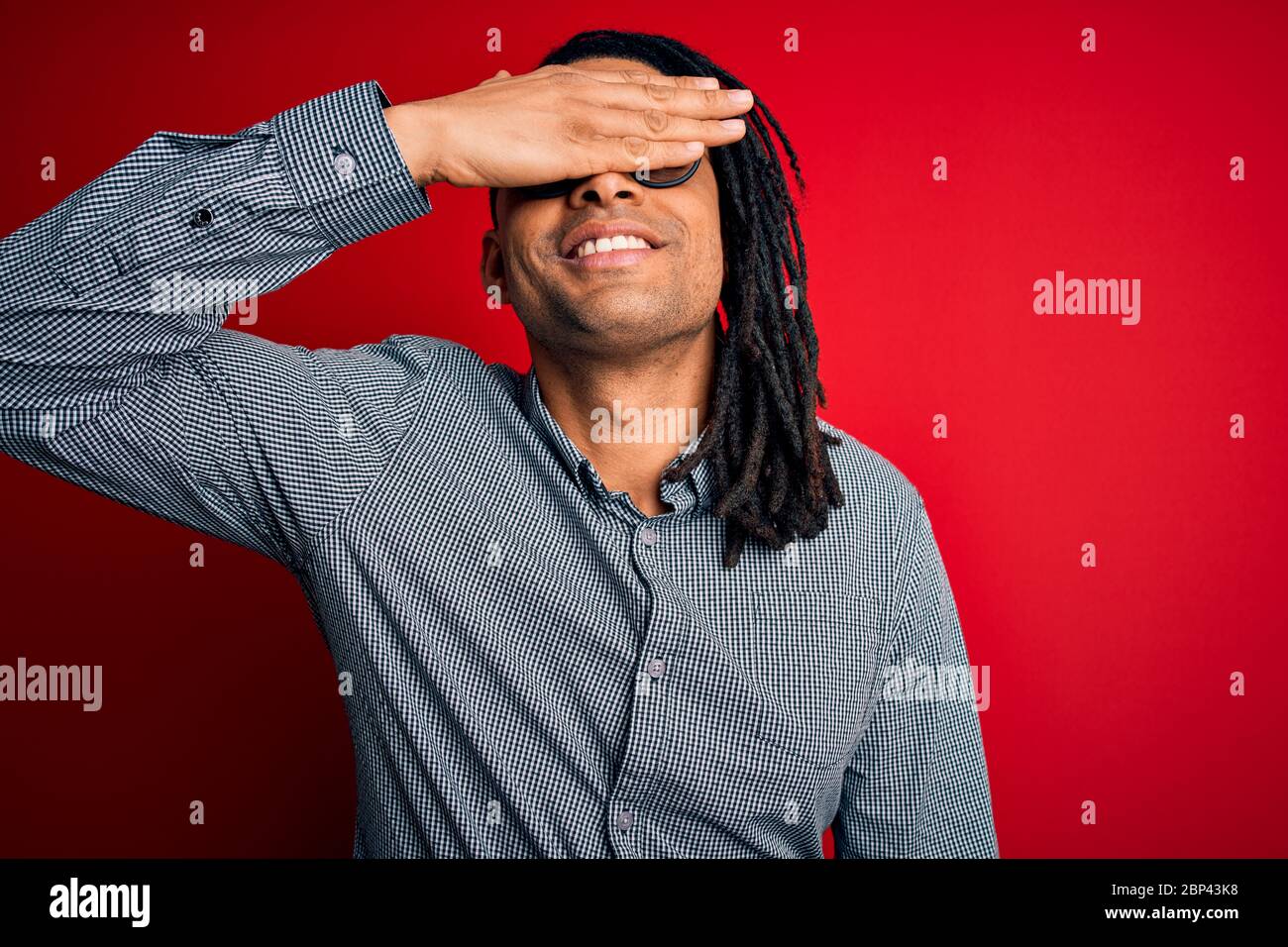Young handsome african american man with dreadlocks wearing casual ...