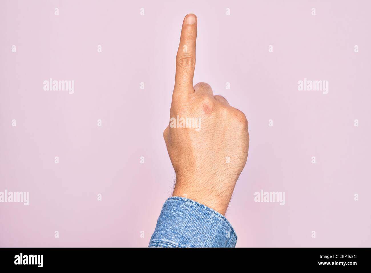 Hand of caucasian young man showing fingers over isolated pink ...